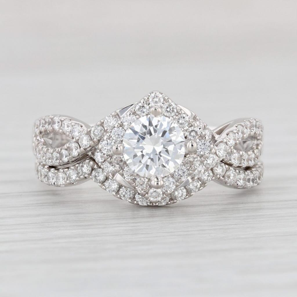 This beautiful ring set features an engagement ring with a contoured fit wedding band. The engagement ring is set with a shimmering round brilliant The LEO solitaire center framed by a lower halo of diamonds with diamond accents along an elegant