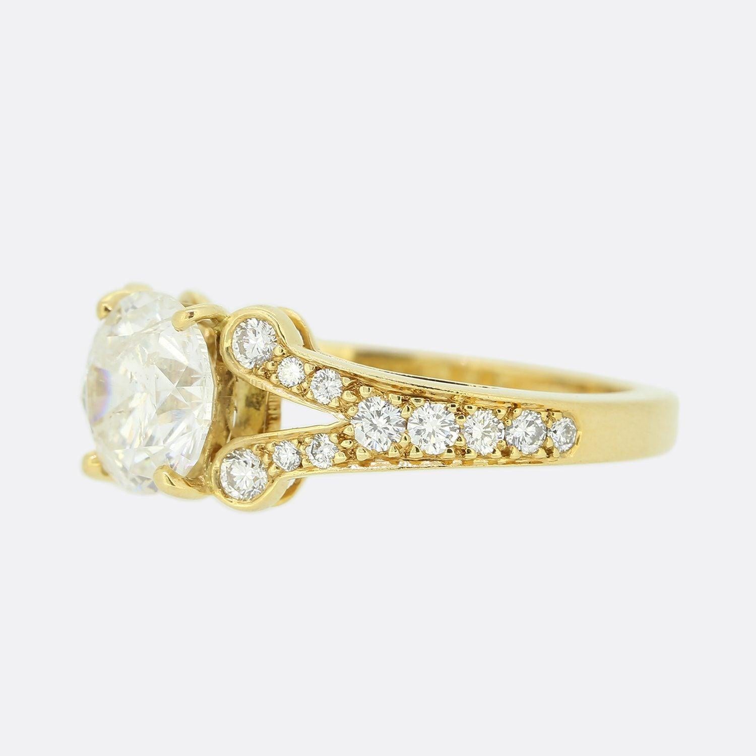 This is an 18ct yellow gold diamond engagement ring. The focal point of the ring is a round brilliant cut diamond set in a 4 clawed mount. The shoulders of the ring split in 2 and are graduated leading to the centre stone.

Condition: Used