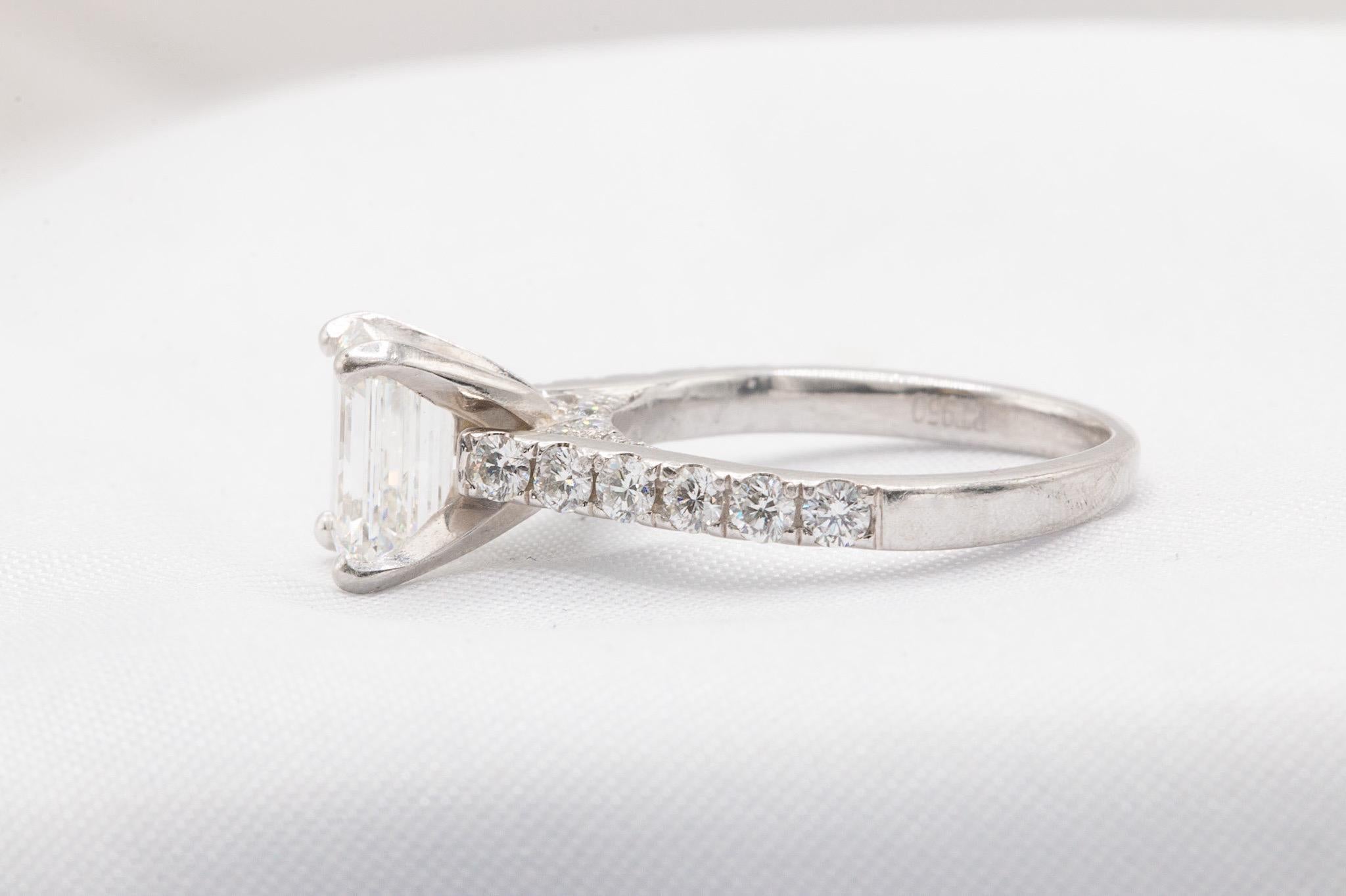 This stunning platinum ring showcases a 1.53-carat emerald cut diamond, graded I color and VS2 clarity, radiating sophistication and elegance. Accompanied by its original GIA certificate (#6372056143), the centerpiece gem is complemented by
