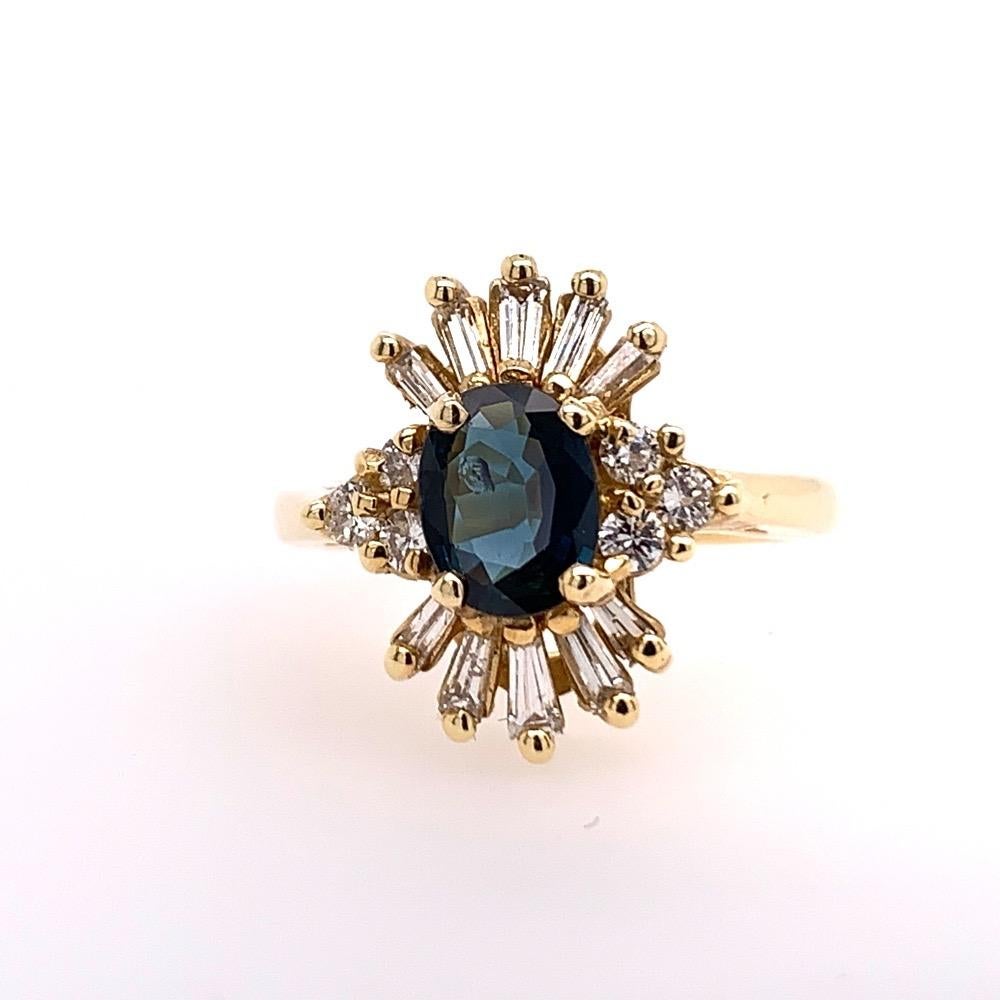 A stunning 1.53 Carat Natural Oval Sapphire and Diamond 14k Yellow Gold Ring (size 6). 

The centerstone is a Natural Oval Deep Blue Sapphire weighing 0.98 carats, measuring 7.1x5.5mm. 

Set in the mounting are 6 round brilliant and 10 baguette