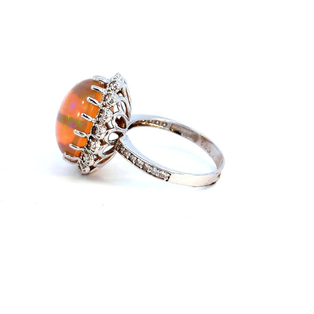 Introducing our stunning 15.30 Carat Fire Opal Ring, a true masterpiece that effortlessly combines the fiery allure of a 15.30-carat fire opal with the timeless sparkle of 1.00 carats of diamonds, elegantly set in a 14K gold band weighing 5.60