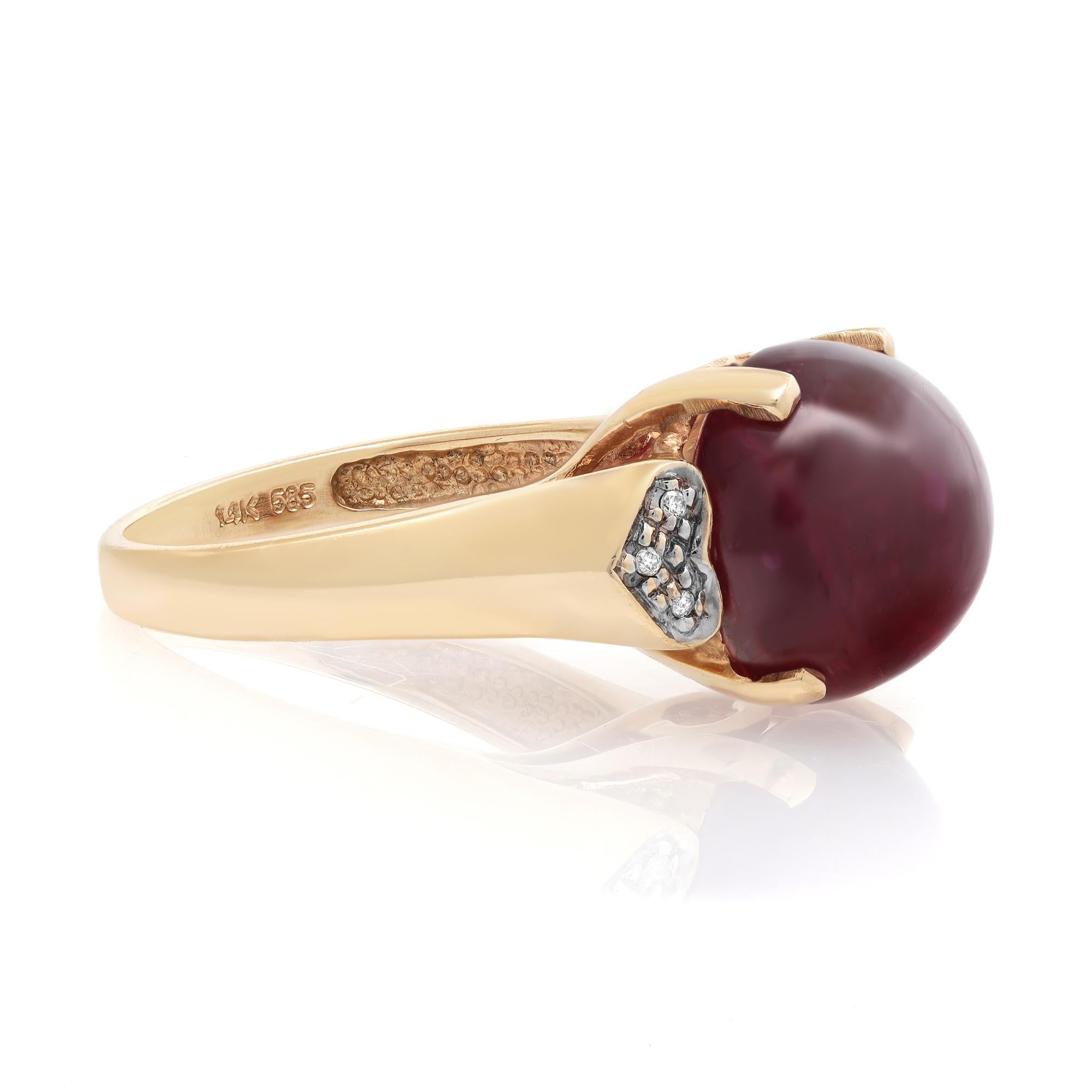 This beautiful Ruby and diamond ladies ring is crafted in fine 14k yellow gold. An excellent prong set round cabochon ruby weighing 15.30 carats is flanked as a center stone with tiny round cut diamonds in a heart shank weighing 0.04 carat. Ring