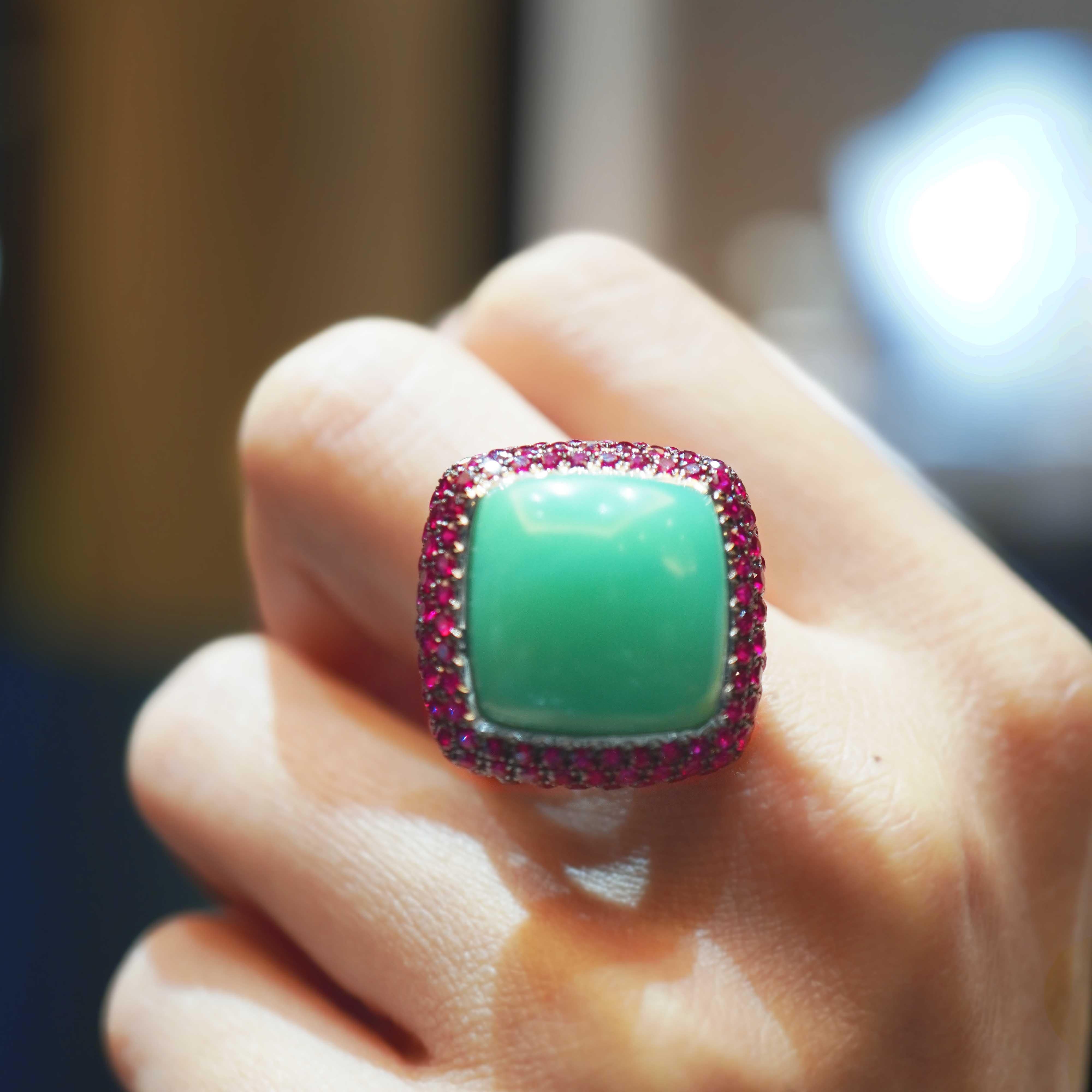 A soothing green 15.35 carat Chrysoprase is set along with 2.98 carat of vivid red ruby from Burma. The ring is made in 18 K gold and is hand made in Hong Kong. Chrysoprase, chrysophrase or chrysoprasus is a gemstone variety of chalcedony (a