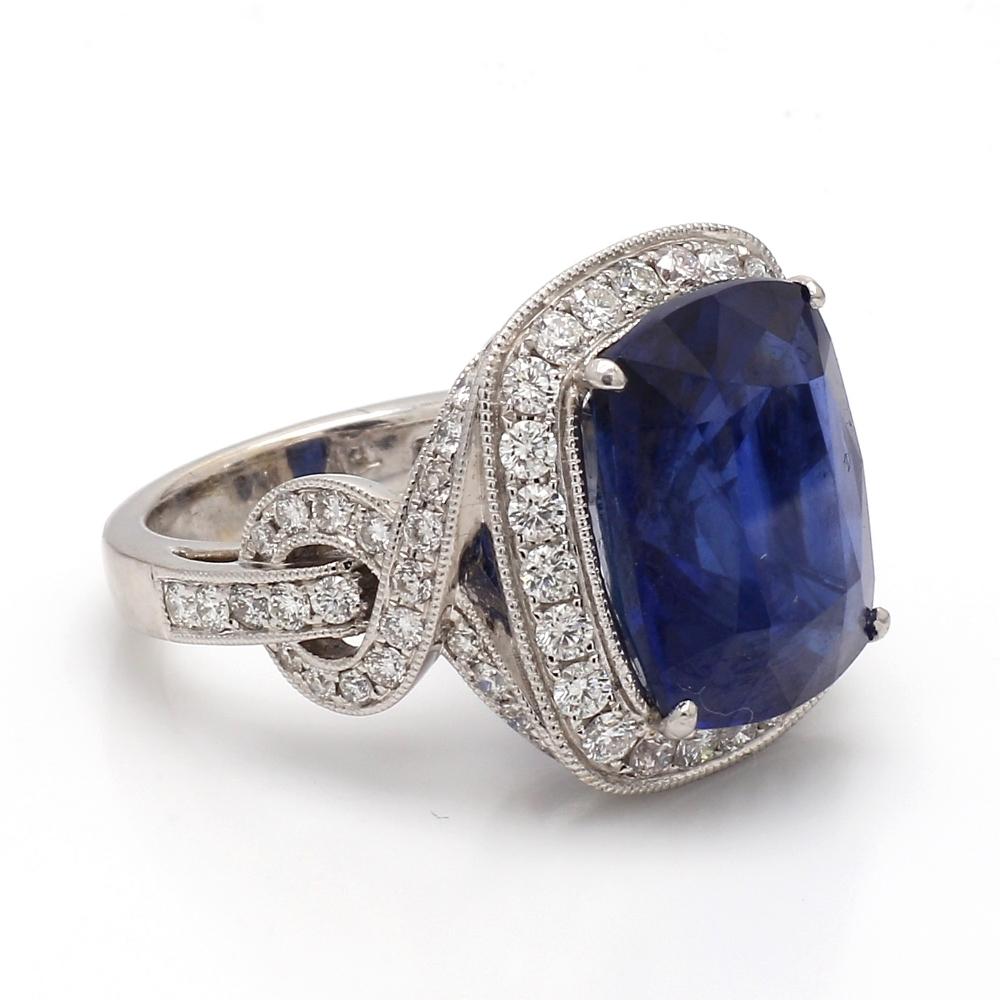 Platinum cocktail ring. Center stone is one (1) cushion cut sapphire weighing 15.38ct. Ring is set with seventy-fice (75) round brilliant cut diamonds weighing approximately 1.50ctw. Ring 14.2 grams and is a size 6.75. 
All questions answered. 
All