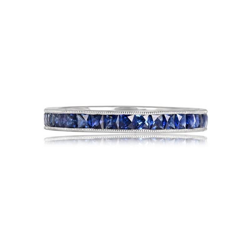 An exquisite eternity band crafted in platinum, featuring French cut sapphires set along the band. With a delicate width of 2.60mm, the band is adorned with fine milgrain detailing, adding a touch of elegance. 

The total weight of the sapphires in