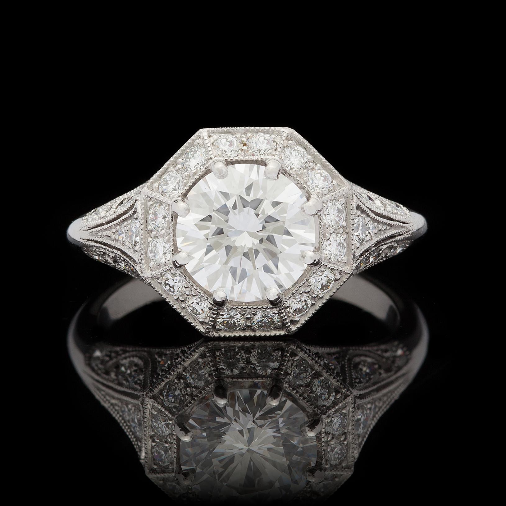 Exceptional design featuring a phenomenal center diamond. This custom French platinum ring by acclaimed designer Sebastien Barier features a 1.53 carat round brilliant cut diamond accented by an octagonal pave diamond border and diamond accented