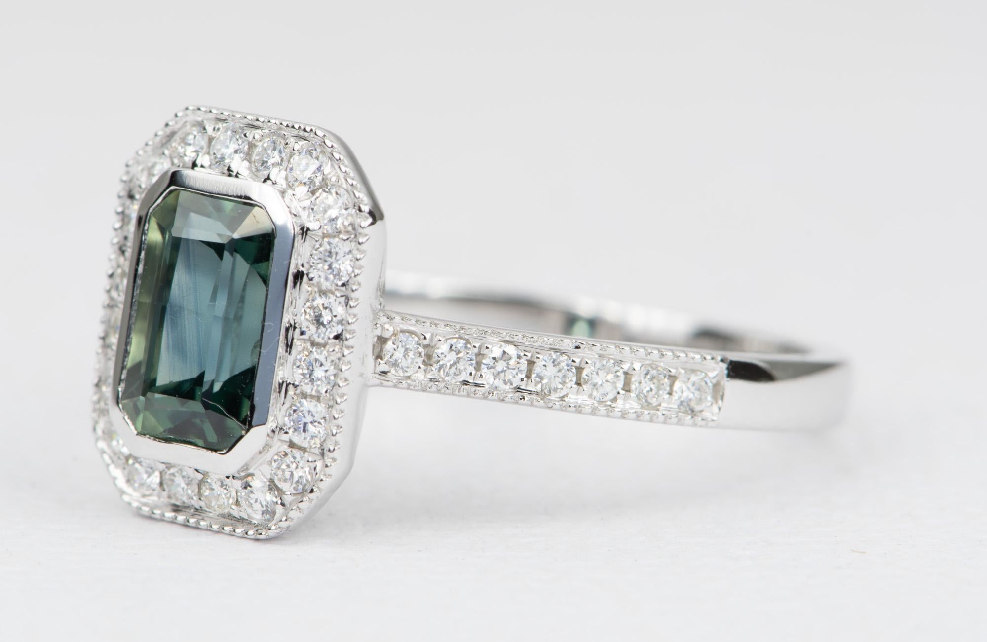 ♥ This 14K white gold ring features a teal blue sapphire in the center, flanked with bright white diamond in a halo style
♥ The shank of the ring is set with delicate milgrain edges and a half eternity diamond pave on the band

♥  Ring size: US 7