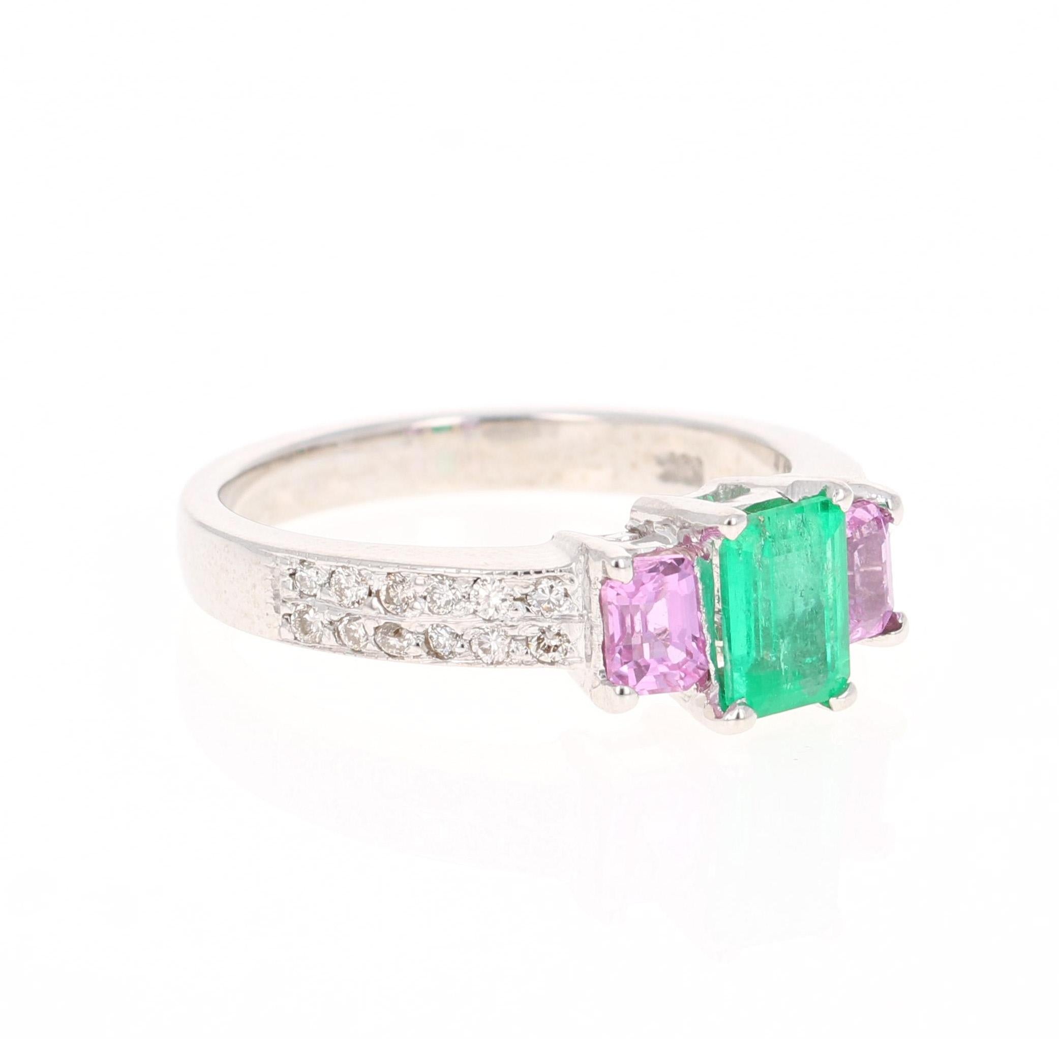 Beautiful and Unique Emerald, Pink Sapphire, and Diamond Three Stone Ring. A beautiful alternative to the classic diamond three stone ring. 

This ring has an Emerald Cut Green Emerald that weighs 0.65 Carats with 2 Emerald Cut Pink Sapphires on