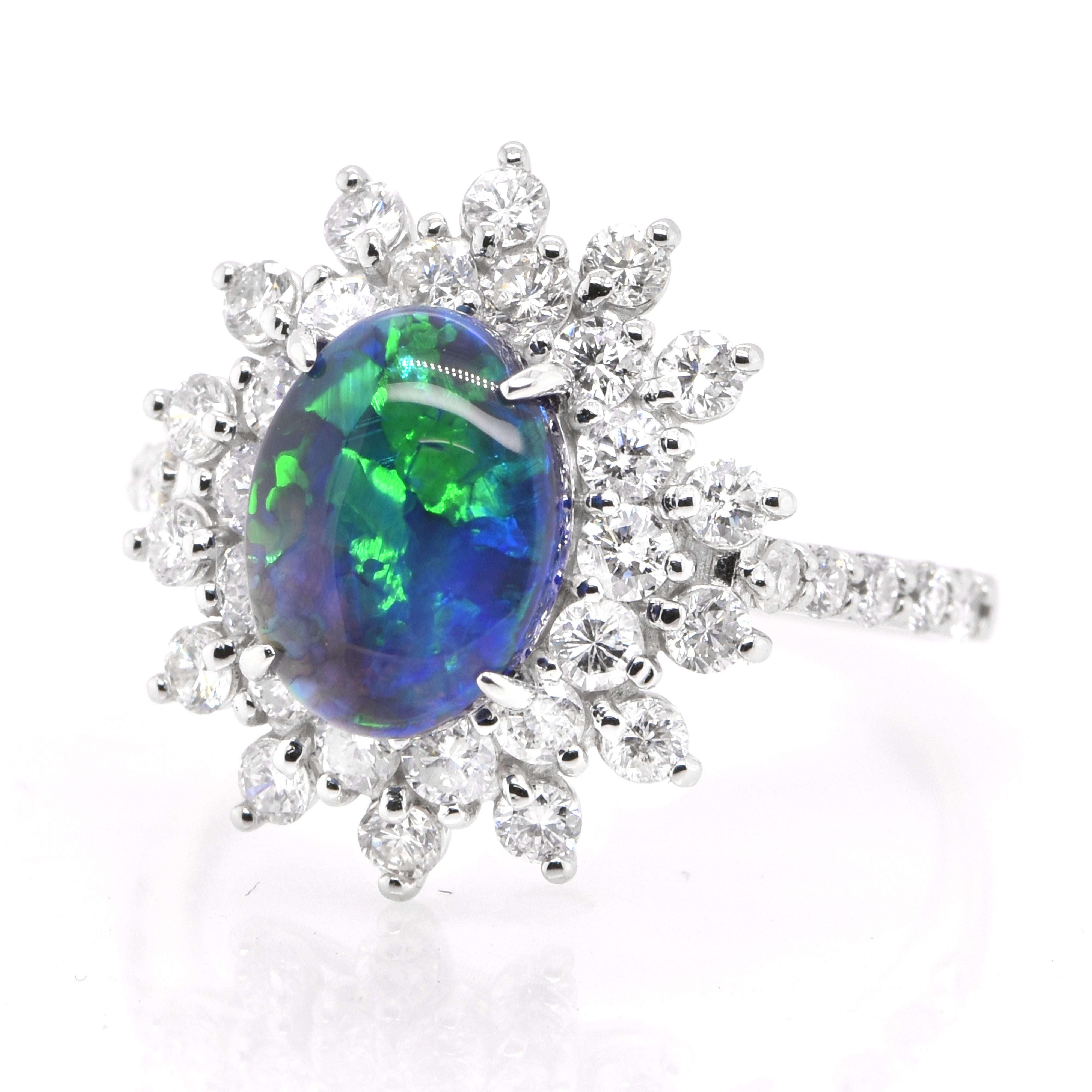 A beautiful ring featuring a 1.54 Carat, Natural, Australian (Lighting Ridge) Black Opal and 1.15 Carats of Diamond Accents set in Platinum. The Opal displays very good play of color! Opals are known for exhibiting flashes of rainbow colors known as