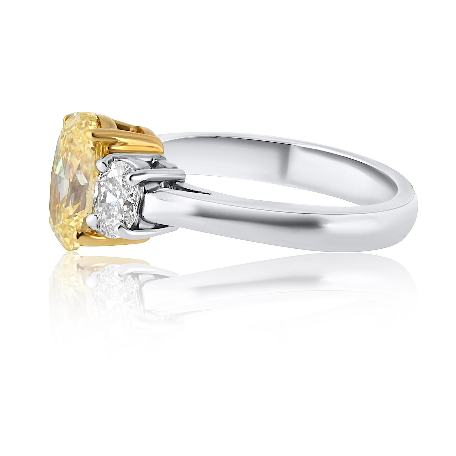 Modern 1.54 Carat Oval Cut Fancy Intense Yellow Three-Stone Diamond Engagement Ring For Sale