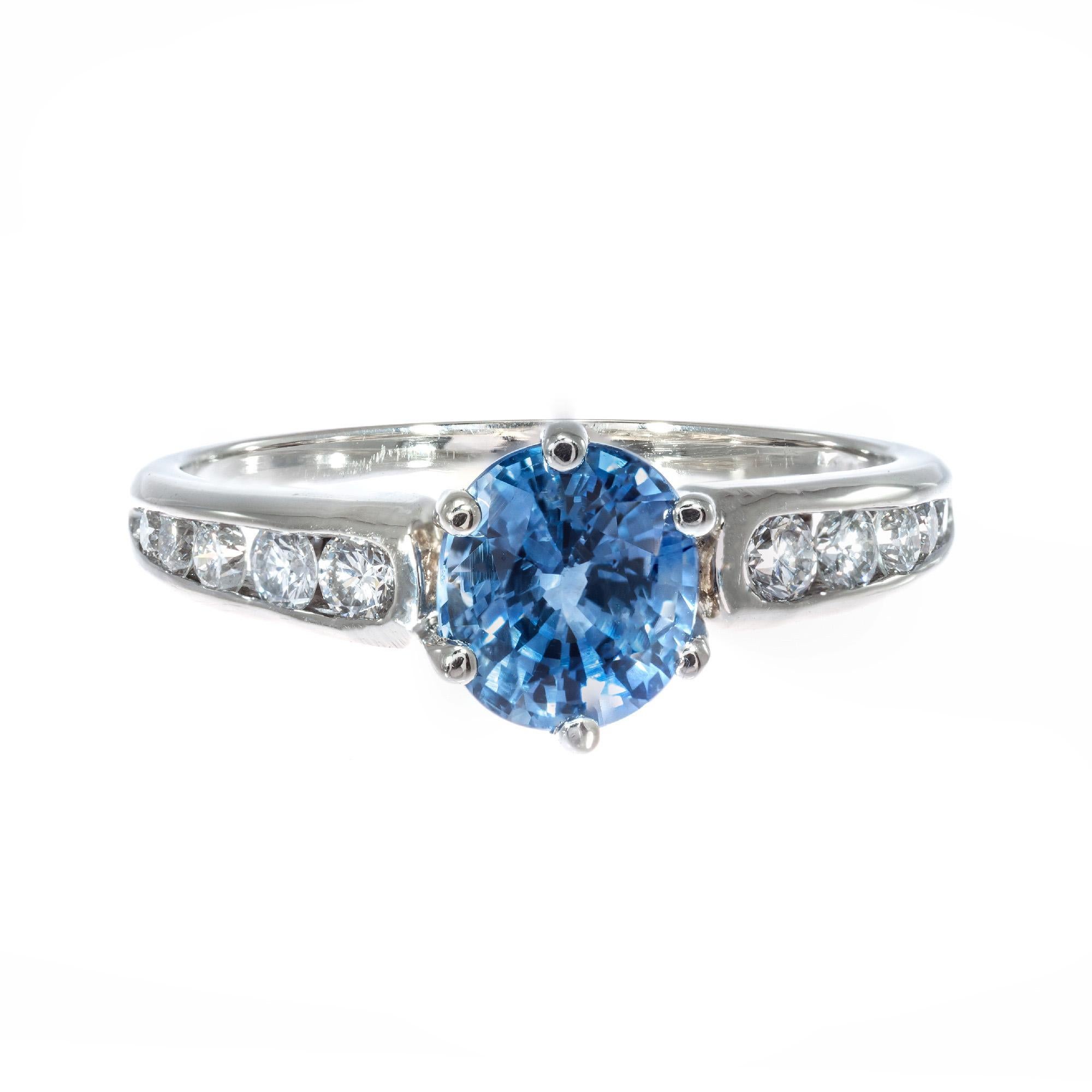 1960's Periwinkle blue sapphire and diamond engagement ring.  AGL certified as simple heat only, no other enhancements. 14k white gold setting with 10 round accent diamonds. 

1 oval mixed cut SI blue sapphire, Approximate 1.54ct AGL Certificate #