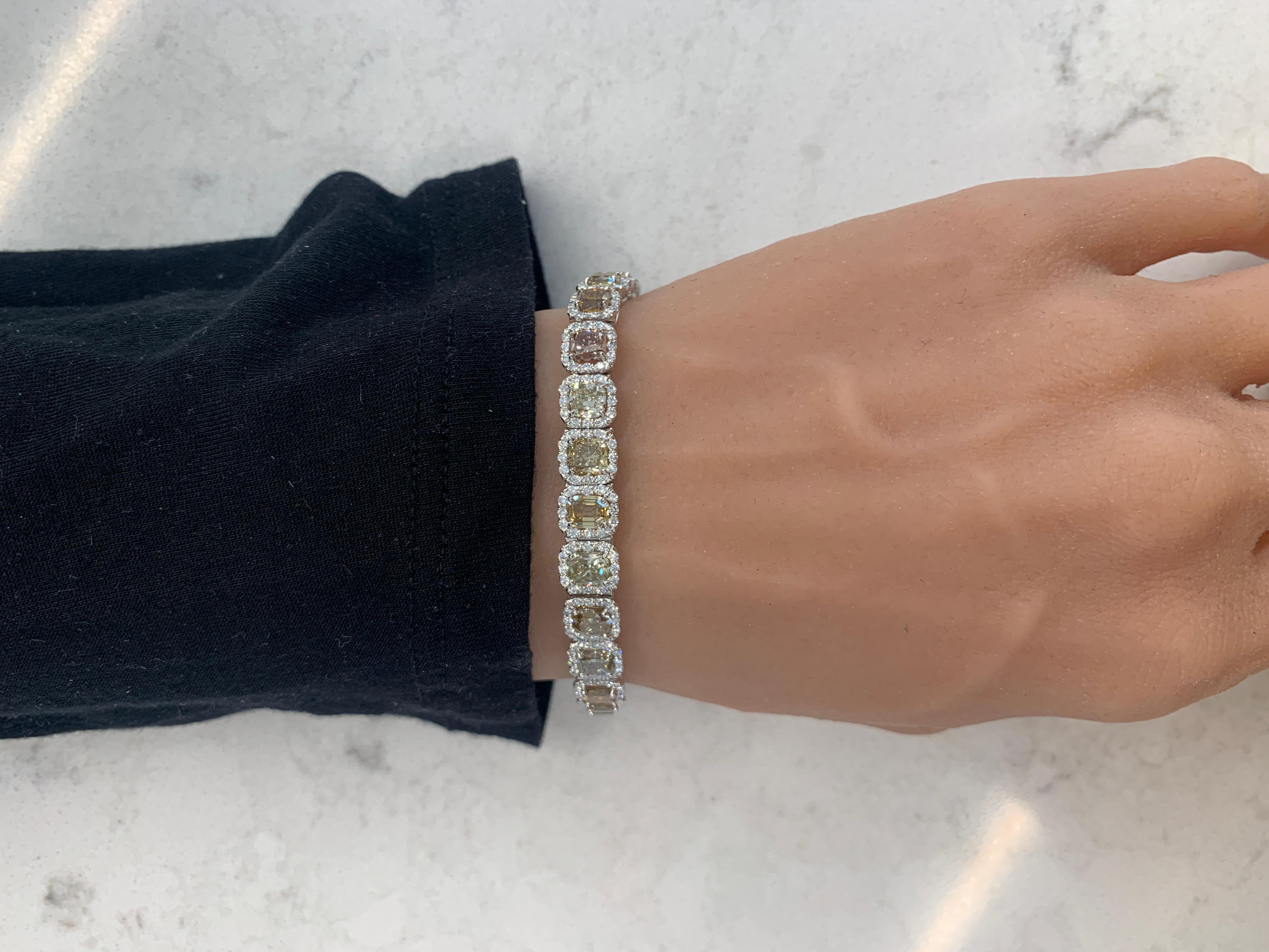 This bracelet consists of 27 fancy cushion cut diamonds that total upto 15.40 carats. It also consists of natural round diamonds that total up to 3.30 carats. And is 7.25 inches in length and set in platinum.