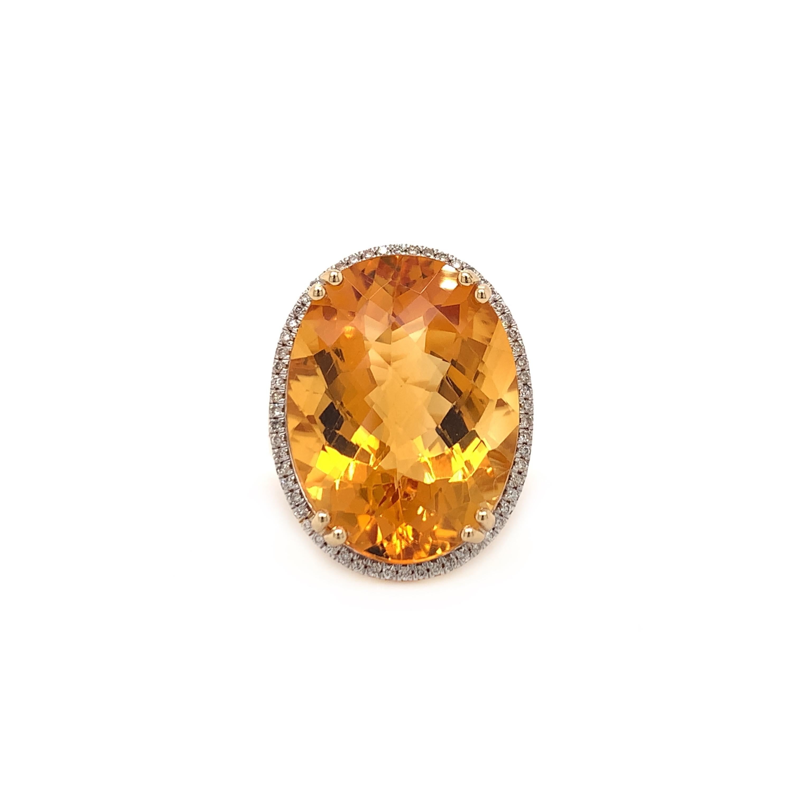 Glamorous large citrine cocktail ring. High brilliance, checkerboard oval faceted, rich golden honey natural 15.45 carat citrine mounted in high profile basket with eight bead prongs, accented with a round brilliant diamond frame. Handcrafted