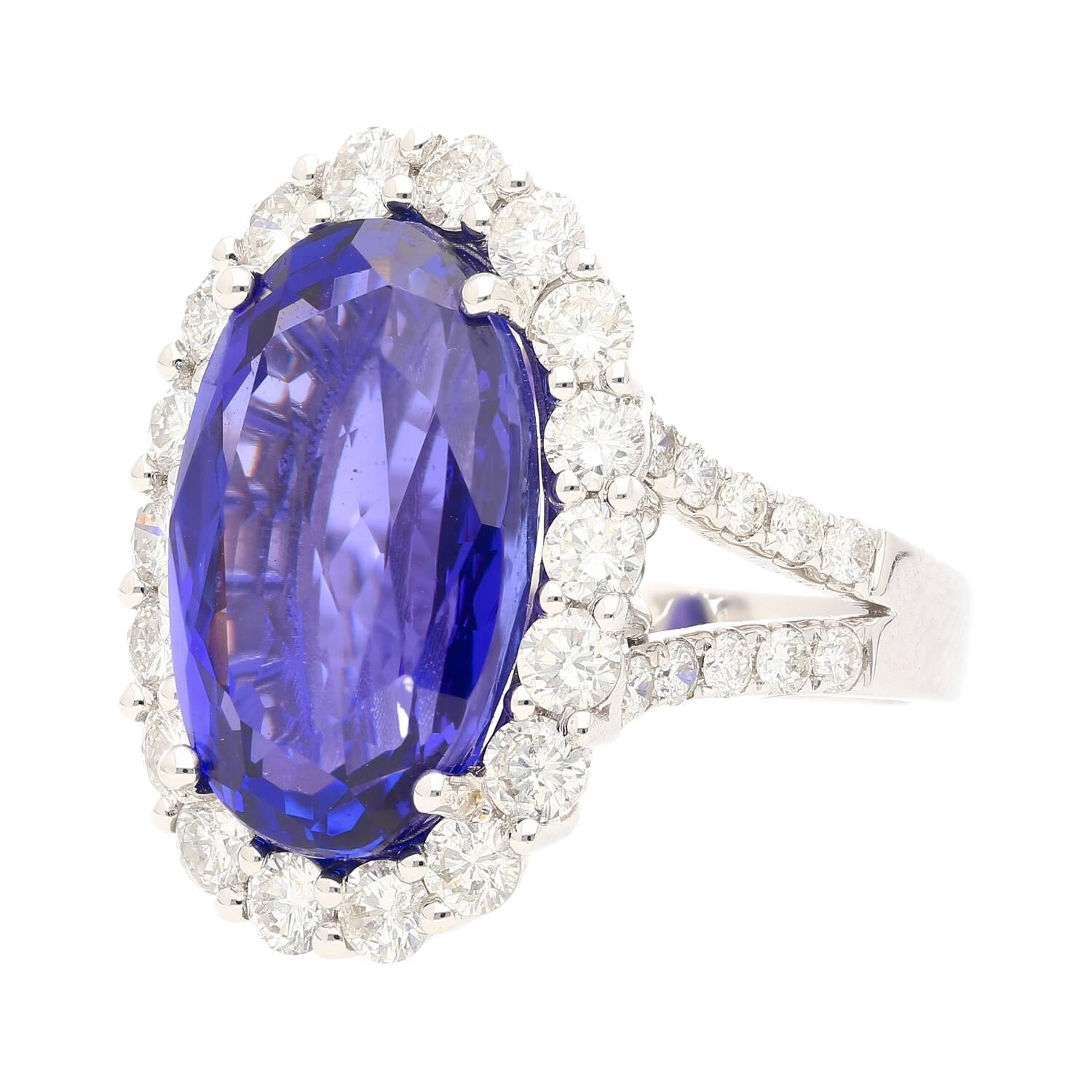 Experience the pinnacle of luxury with this exquisite ring, featuring a magnificent 15-carat oval cut natural tanzanite. The tanzanite, of super fine grade V-AAA quality, showcases a captivating deep violet hue and eye clean clarity that captures