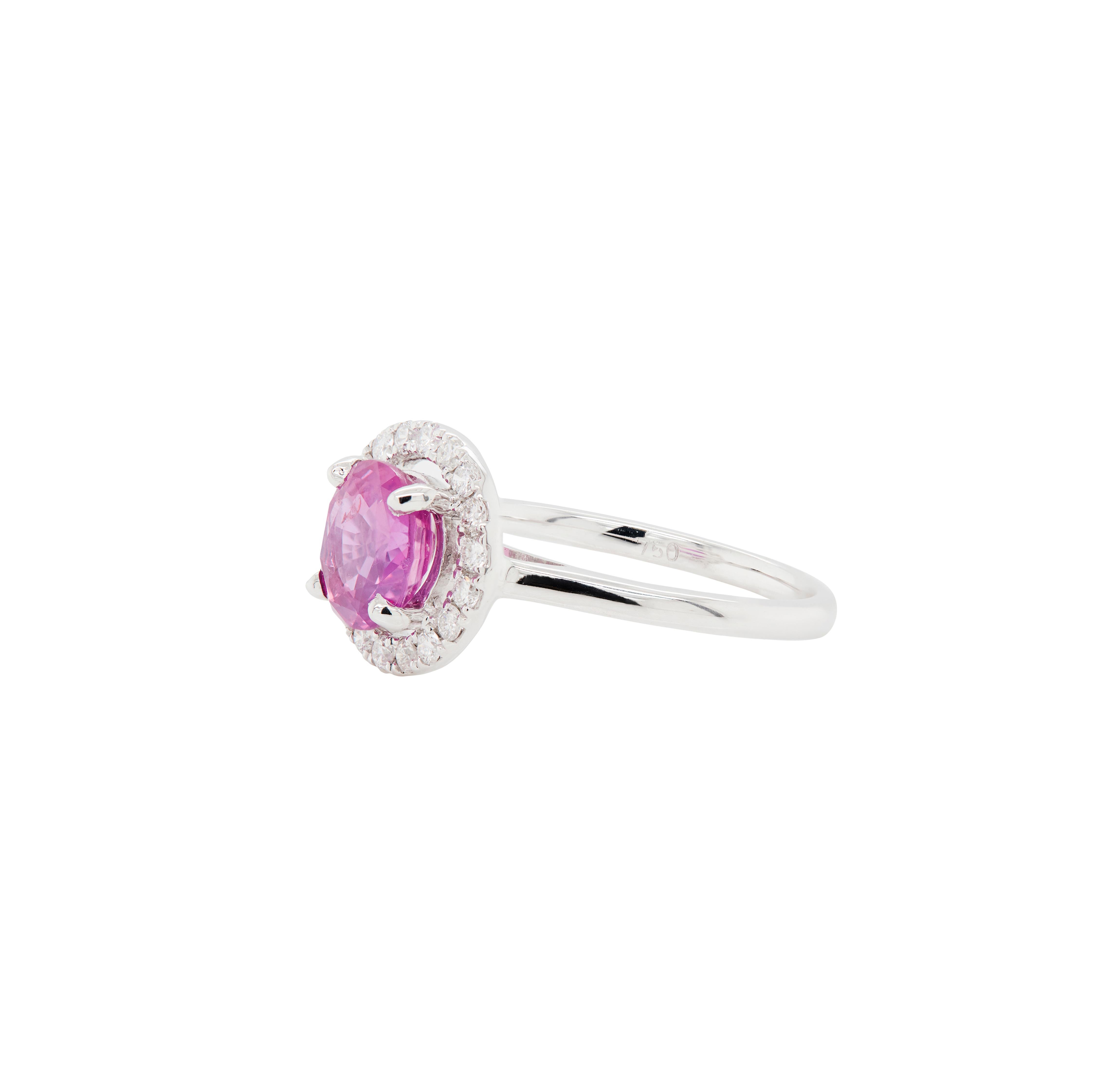 Delicate and full of colour, this 18 carat white gold engagement ring speaks of timeless beauty and cherished moments together.

At the centre of this exquisite piece sits a 1.54ct vibrant pink round sapphire, glowing with rich colour and warmth,