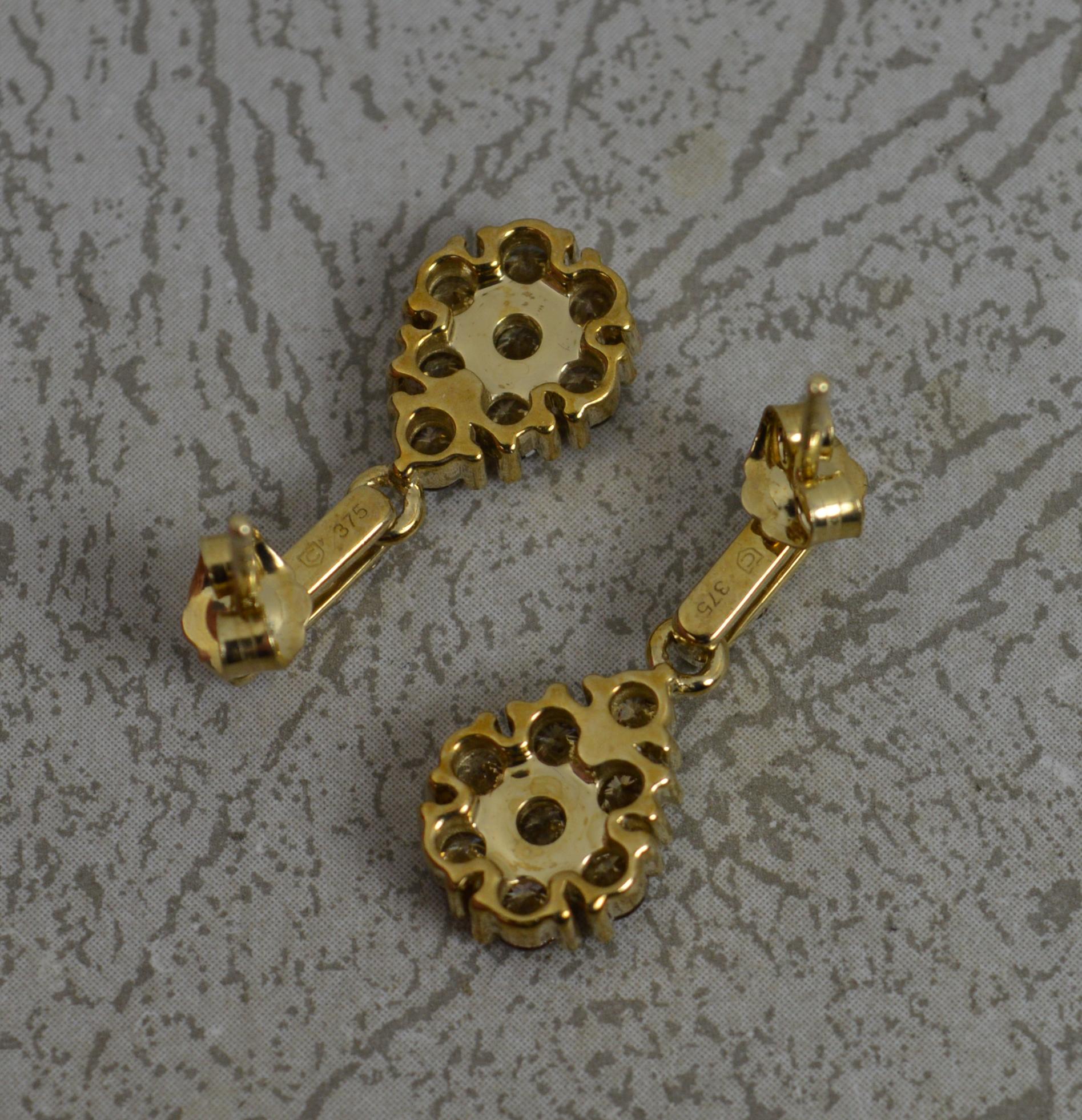 A fine pair of drop dangle earrings.
Solid 9 carat yellow gold example.
Set with round brilliant cut natural diamonds, champagne colour, 1.55 carats total.
3.3 grams. 20mm long drop. 8.5mm wide.
Condition ; Excellent. Clean stones. Crisp design.