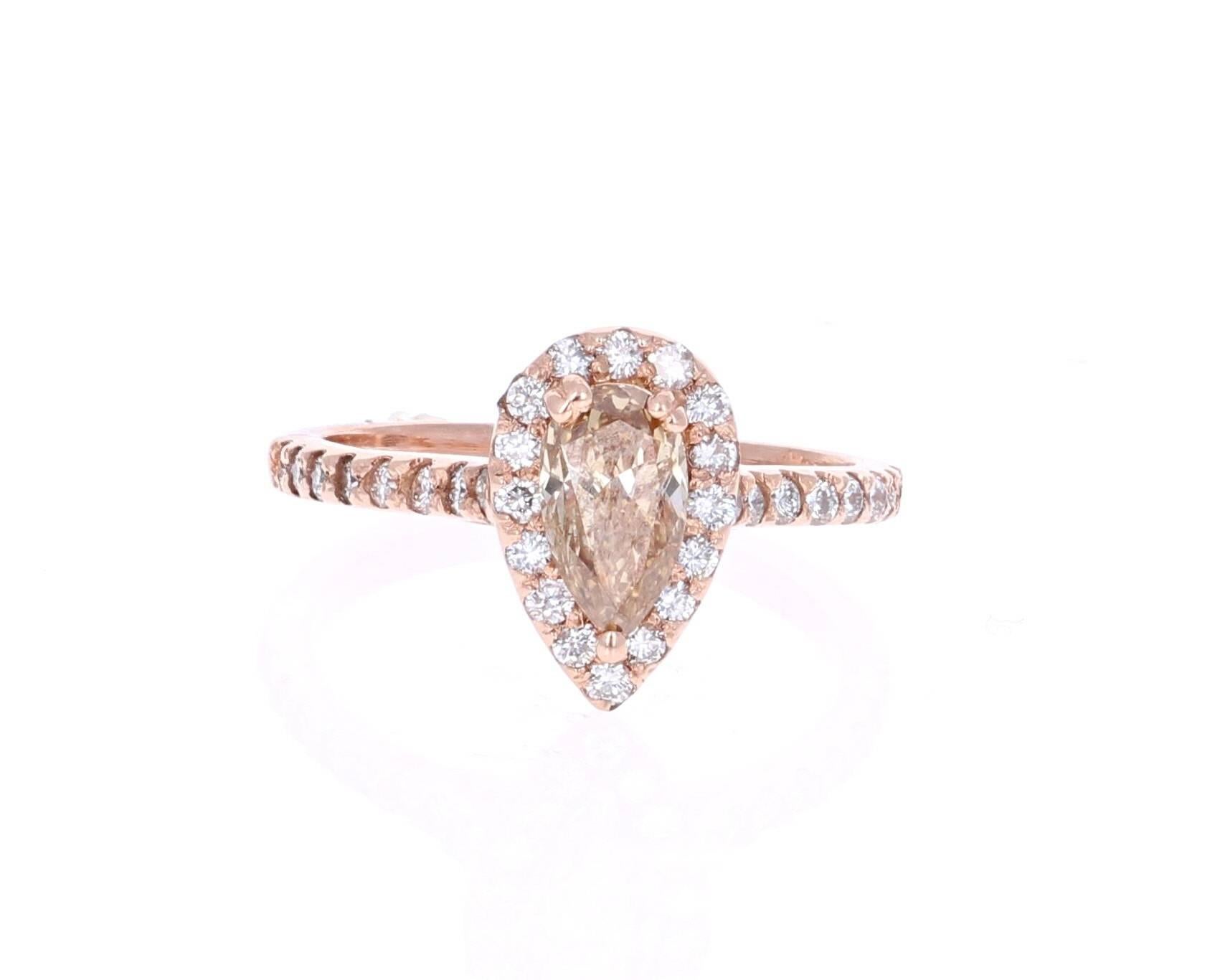 A gorgeous 1.55 Carat Fancy Pear Cut Diamond Engagement Ring in 14K Rose Gold that will leave her breathless! 

The center stone is a fancy colored Champagne Pear Cut Diamond weighing 1.02 carats.  It is surrounded by a halo of 32 Round Cut diamonds