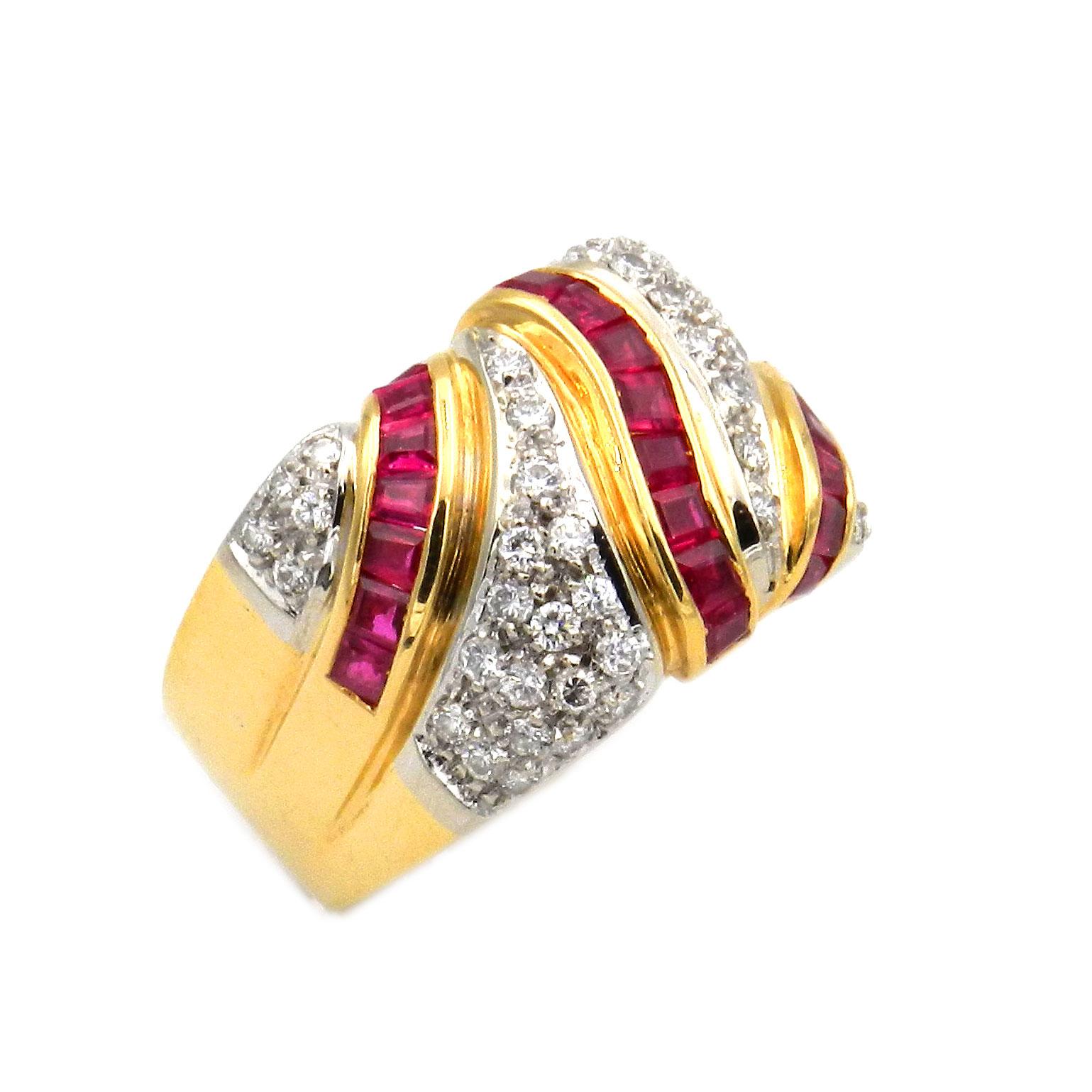 1.55 Carat Ruby and Diamond Band Ring in 18K Gold

This modern, sporty and elegant natural ruby and diamond band ring is a statement. The wide face decorated with three diagonal lines of luscious square cut rubies, invisible set and weighing 1.55