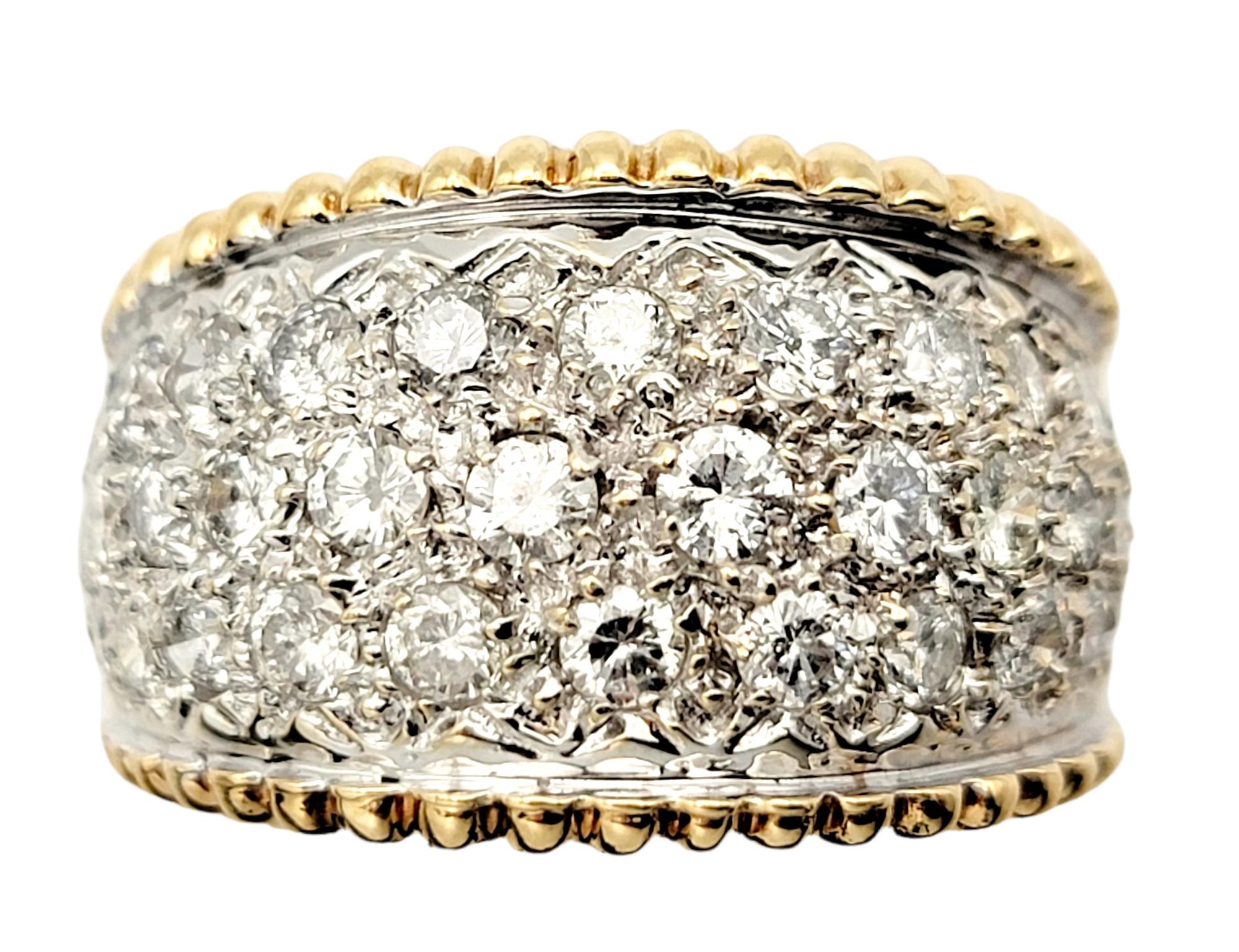 Ring size: 6.75

This dazzling diamond band ring wraps elegantly around the finger and fills it with sparkle. Featuring a wide, two tone design, the glittering natural stones catch the light from every angle, making it shimmer and shine beautifully.