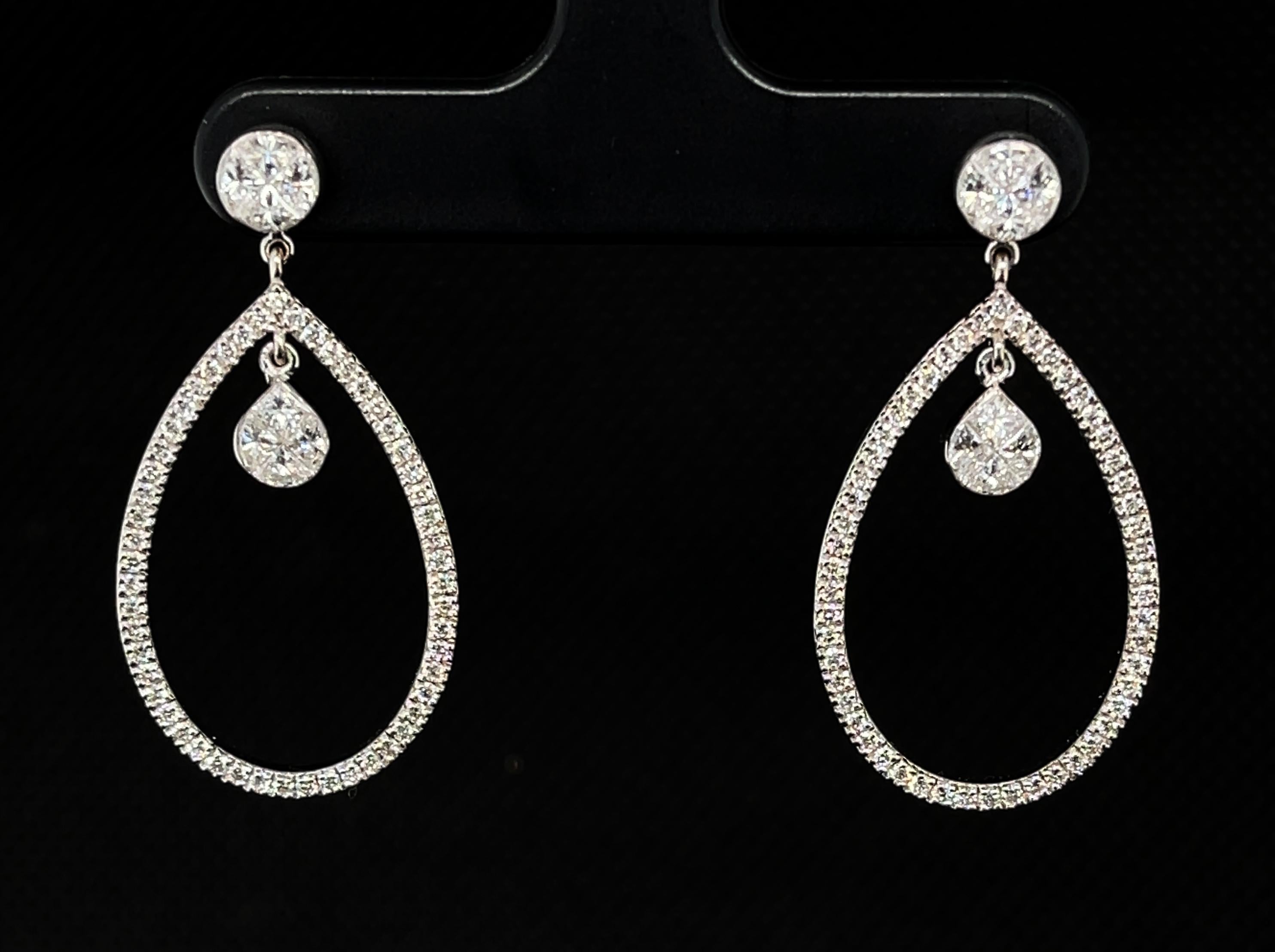 These earrings are classic with a twist! They feature triangular cut diamonds, princesses cut diamonds and round brilliant cut diamonds that weigh a total of 1.55 carats. These diamonds catch the light in different ways because of their varied cuts,