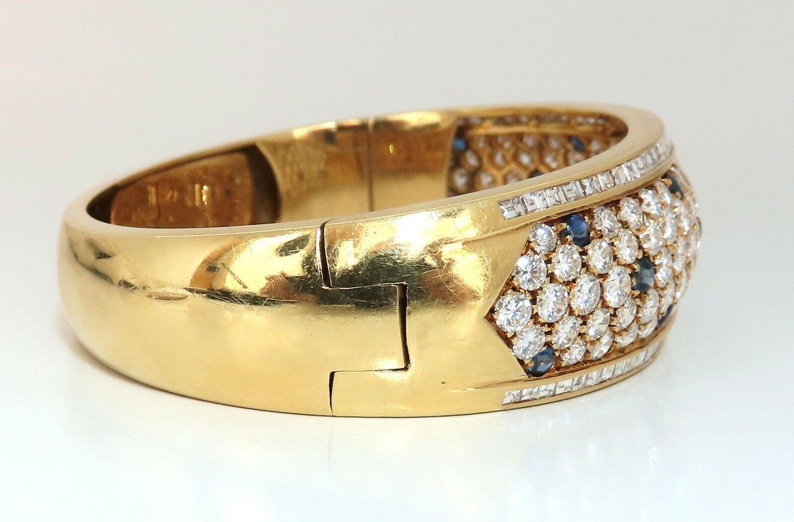 Vintage Cluster Sapphire & Diamond Bangle 

1.50ct natural sapphires bracelet.

Blue, Transparent & round cuts.

14.00ct. natural round & baguette diamonds:

 E-F color Vs-2 clarity.

18kt. yellow gold 

53.6 Grams.

.74 inch wide

.28 inch depth