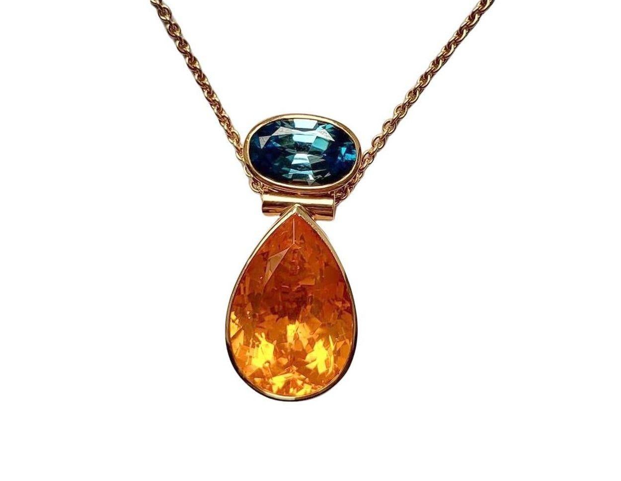 This magnificent creation of fine jewelry was made by Georg Spreng for Wagner Preziosen, who provided the  gemstones. 
The sparkling luscious orange of the 15.52 carat fire opal drop is complemented by the radiant blue of the 7.01 carat oval zircon.