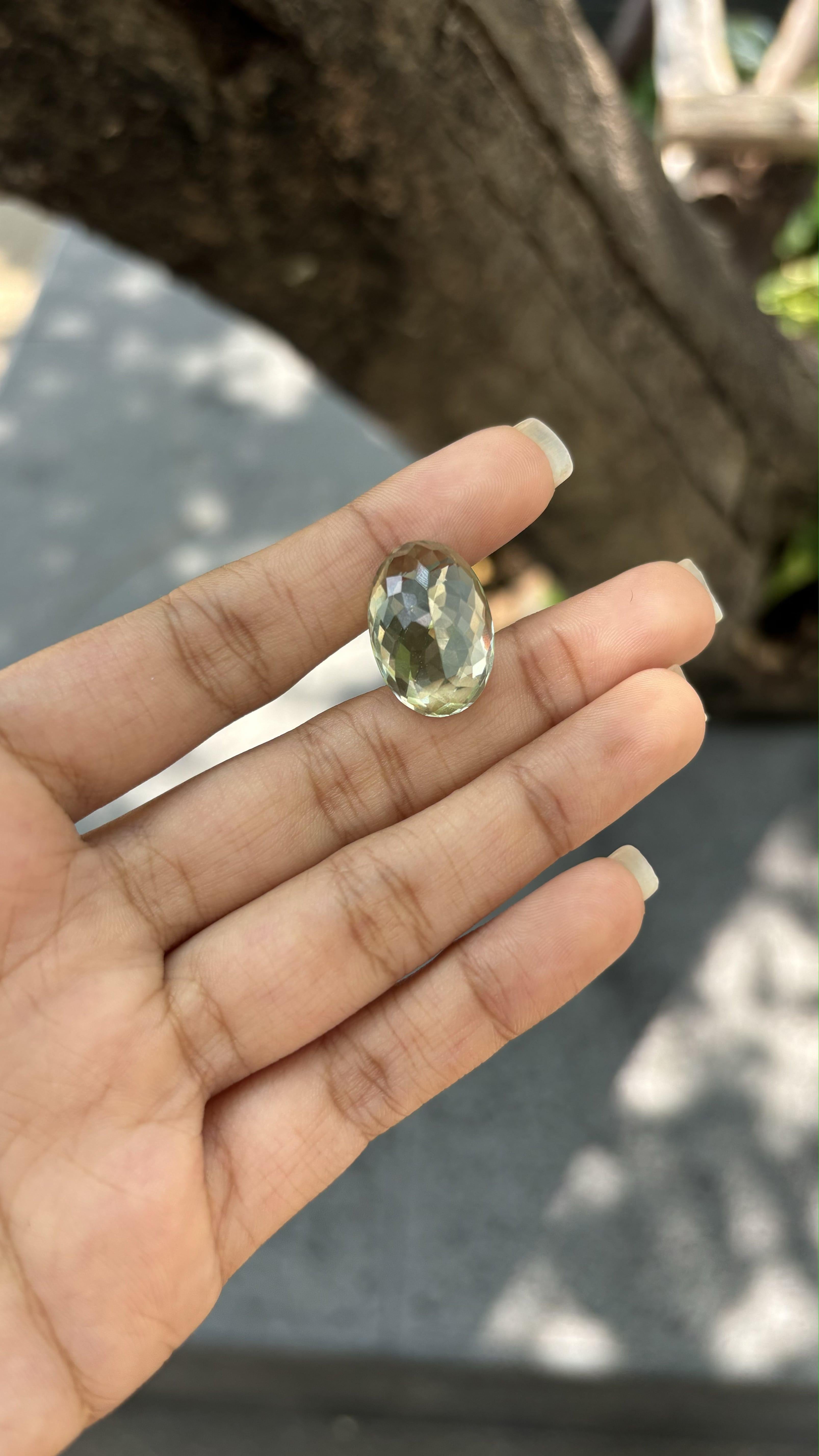 A gorgeous 15.55 Carat Quartz gemstone. It is completely natural and it is a clean stone.  The quartz has a unique and breath-taking  green color that is sure to allure you at first sight! It is cut to perfection in a distinct and fancy oval