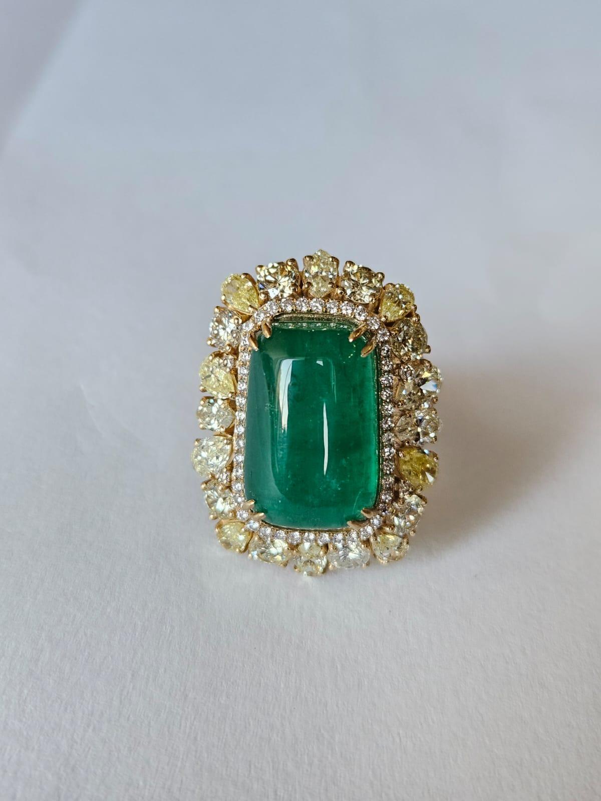 Modern 15.56 carats, natural Zambian Emerald Cabochon & Yellow Diamonds Cocktail Ring For Sale