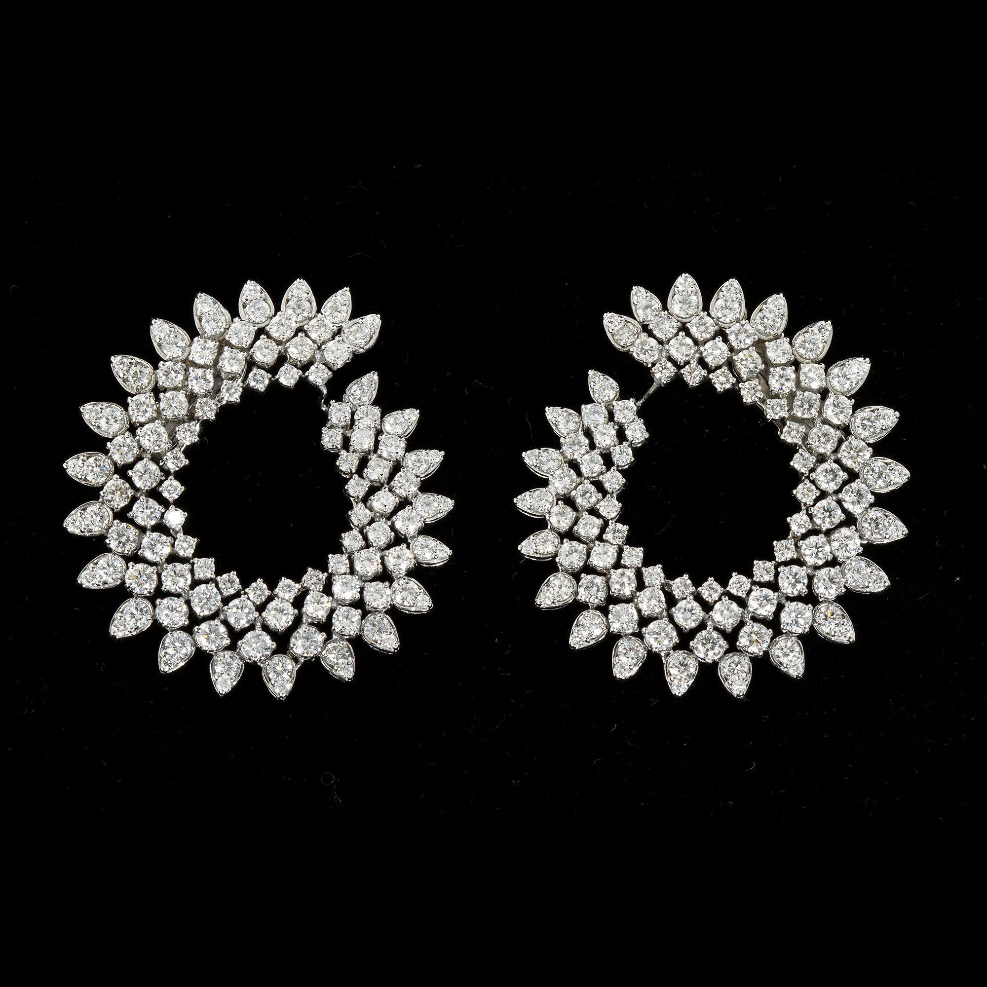 Stunning eye catching Diamond earrings. weighing close to 16 carats of round brilliant cut Diamond. Set in 18k white Gold. measuring 2 inch in diameter,
These attractive brilliant Diamond earrings, are truly red carpet ready