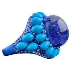 Anello da cocktail con tanzanite cabochon, turchese e diamanti da 15,59 carati