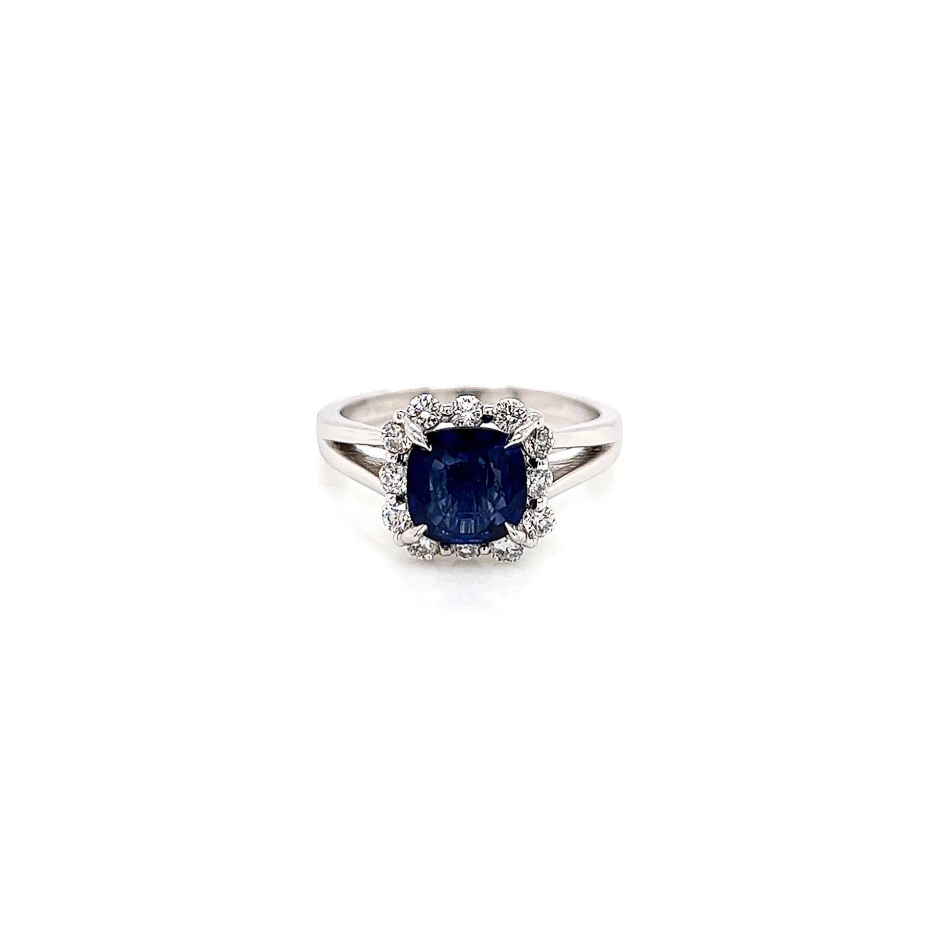 2.02 Total Carat Sapphire Diamond Engagement Ring

-Metal Type: 18K White Gold
-1.55 Carat Cushion Cut Blue Sapphire
-0.47 Carat Round Side Diamonds 
-Size 6.75

Made in New York City.
