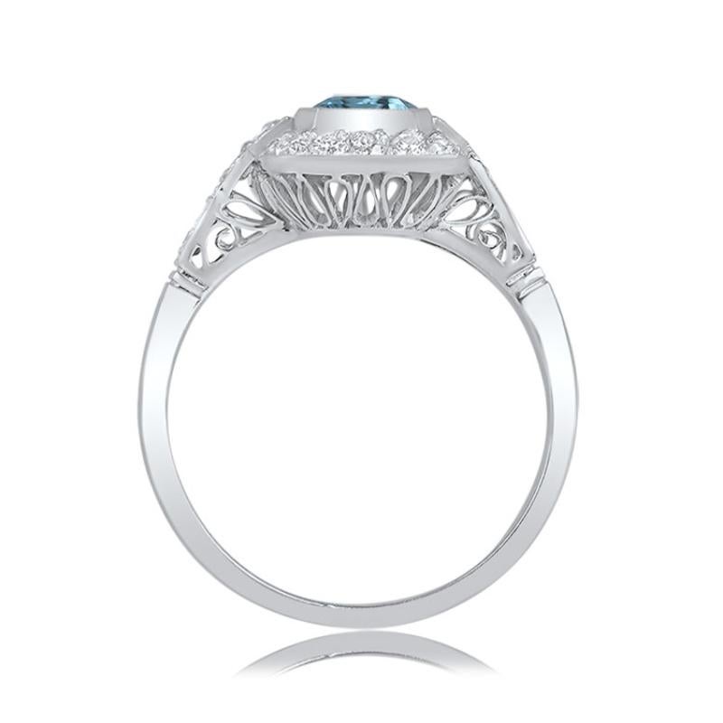 A captivating aquamarine engagement ring featuring a 1.55-carat gemstone with vivid blue saturation. The aquamarine is encircled by a row of diamonds, with additional diamond sections adorning the shoulders. Crafted in platinum, the ring boasts