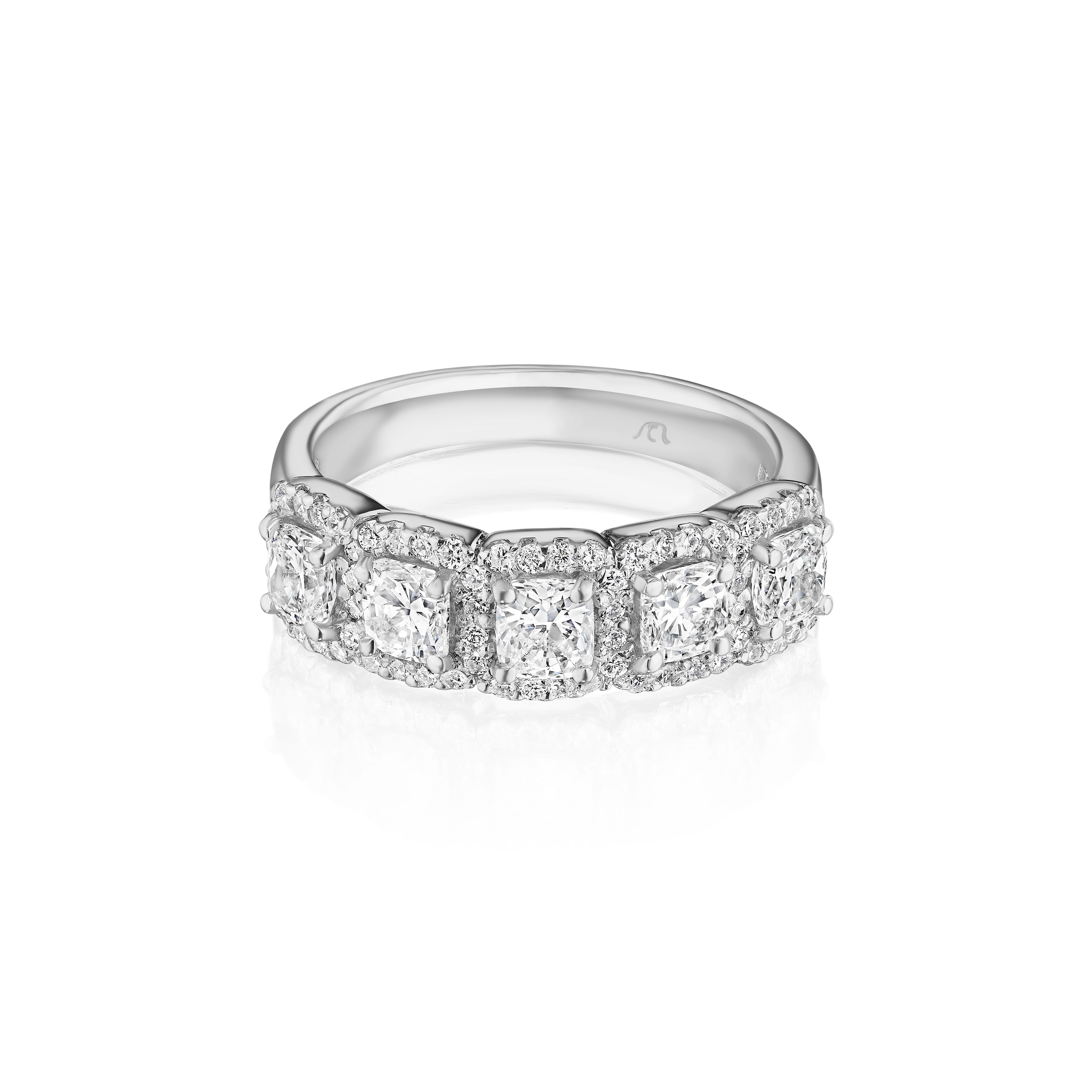 • Crafted in 18KT gold, this band is made with 5 cushion cut diamonds which are framed by a delicate halo comprised of round brilliant cut diamonds. The band has a combining total weight of approximately 1.55 carats.

Worn beautifully on its own, or