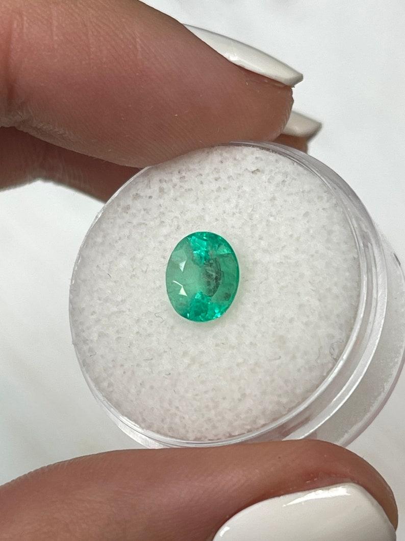 Stone: Emerald
Weight: 1.55-carats
Shape: Oval Cut
Clarity: Semi-Transparent
Luster: Good
Color: Light Green
Measurements: 7.91mm x 6.44mm x 5.74mm
Geographic Origin: Colombia
Treatment: Natural, Oiling

Comments: Due to their growth conditions in