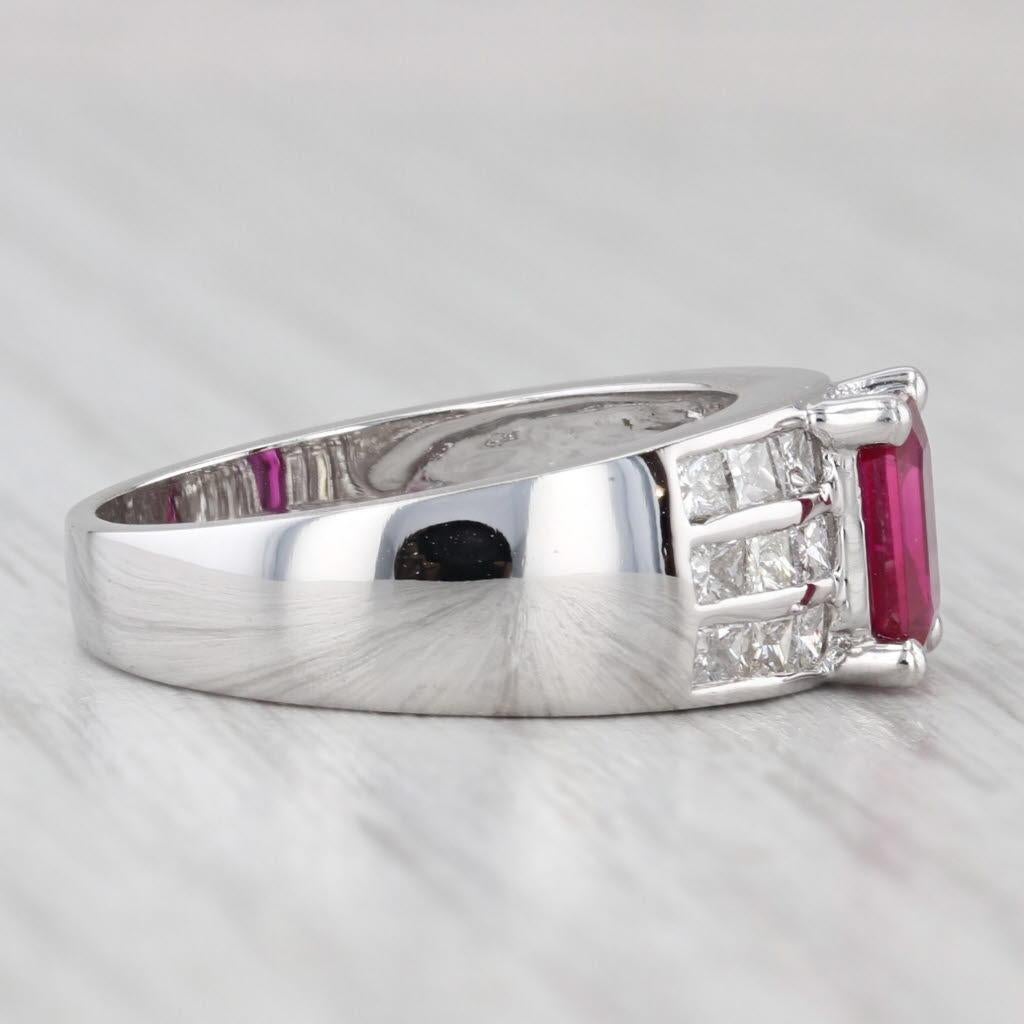 Gemstone Information:
- Natural Ruby -
Carats - 0.85ct 
Cut - Emerald
Color - Red
Treatment - Routinely Enhanced 

- Natural Diamonds -
Total Carats - 0.70ctw
Cut - Princess Brilliant
Color - G - H
Clarity - SI2 - I2

Metal: 18k White Gold
Weight:
