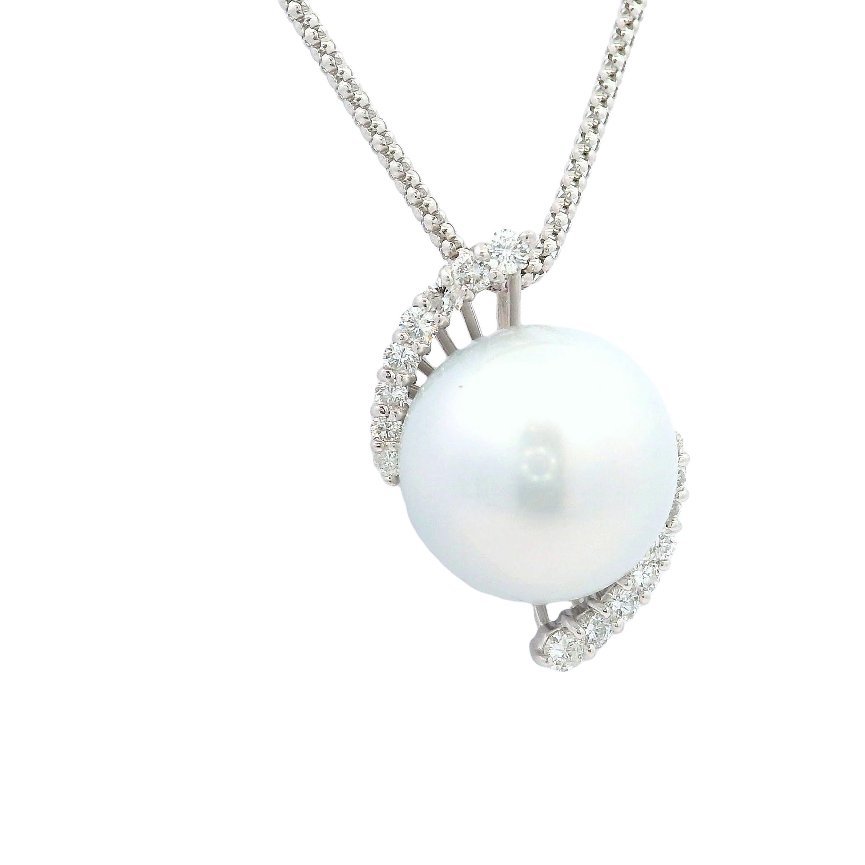 A refined pendant necklace featuring a 15.5mm South Sea pearl. The pearl exhibits a lustrous white color with a smooth and vibrant nacre quality making the pearl glow in the light. It is elegantly accented by 0.60 carats of round-cut diamonds,