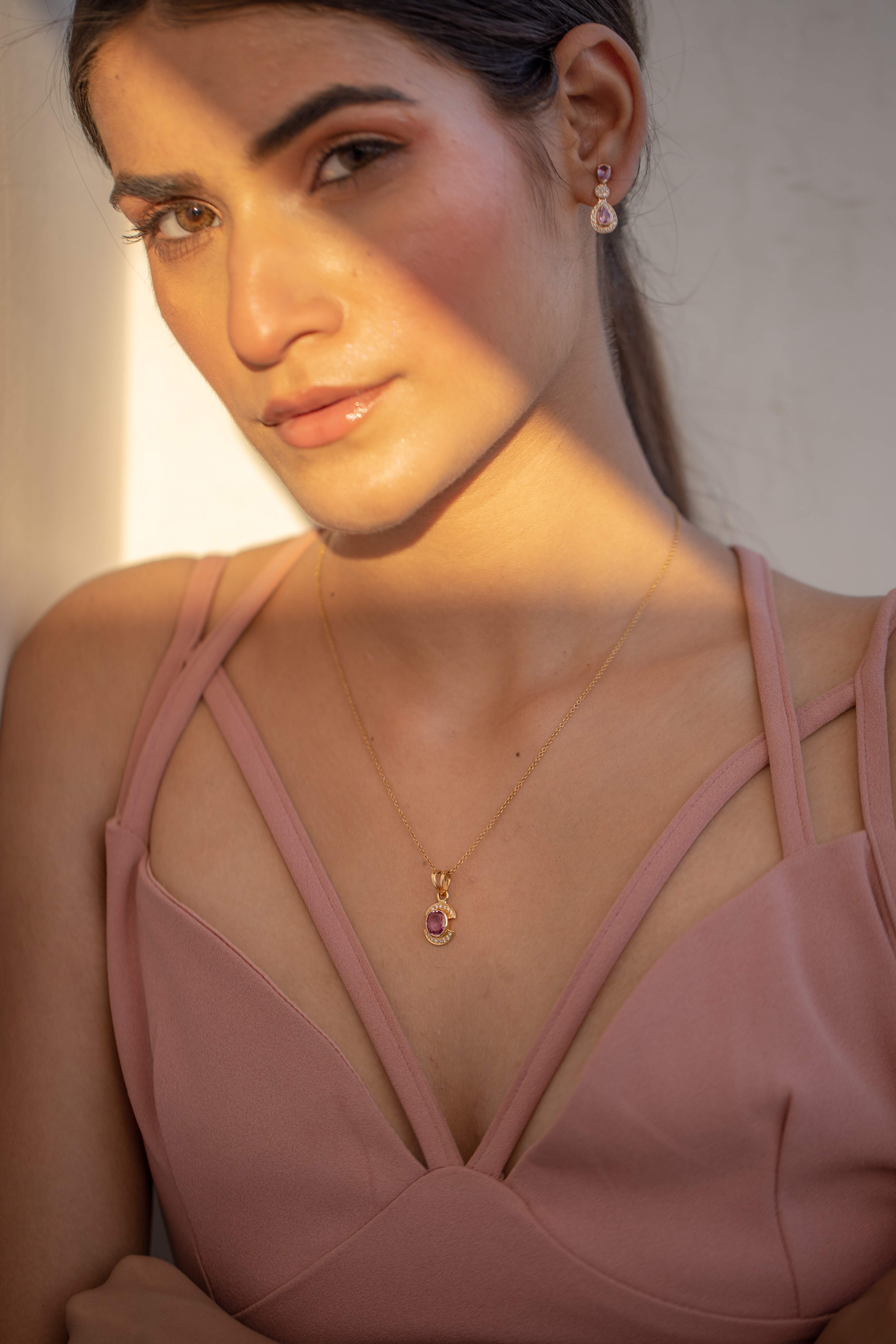 Pink Sapphire Pendant in 18K Gold with Diamonds. It has a oval cut sapphire studded with diamonds that completes your look with a decent touch. Pendants are used to wear or gifted to represent love and promises. It's an attractive jewelry piece that