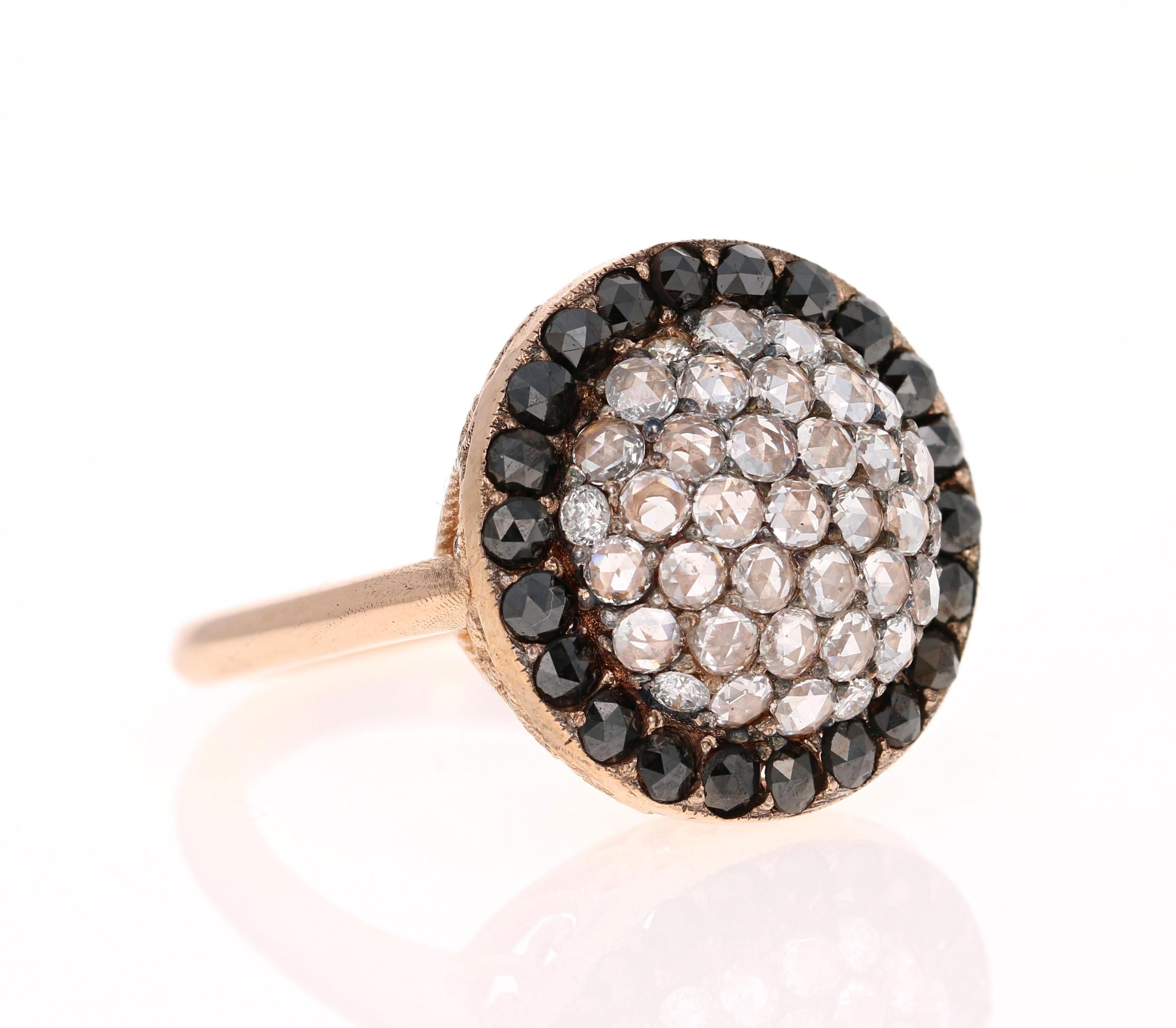 This ring has a beautiful cluster of 38 Rose Cut Diamonds that weigh 0.58 Carats and 22 Black Round Cut Diamonds that weigh 0.97 carats. The total carat weight of the ring is 1.55 carats. 

The ring is made in 18 Karat Rose Gold and weighs