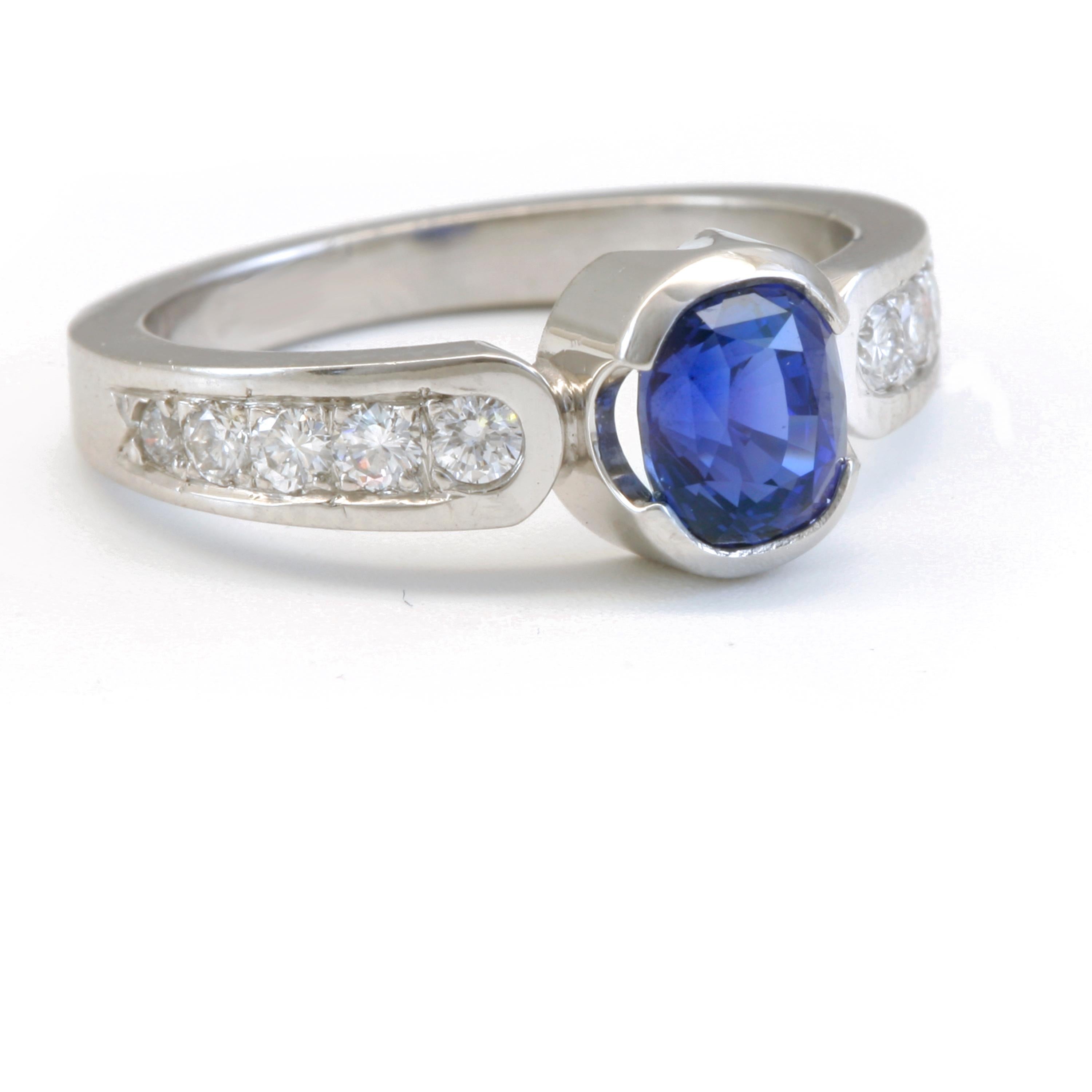 1.56 Carat Blue Sapphire with .34 ctw Diamonds in Platinum. Tapered band, 4 x 3mm band.