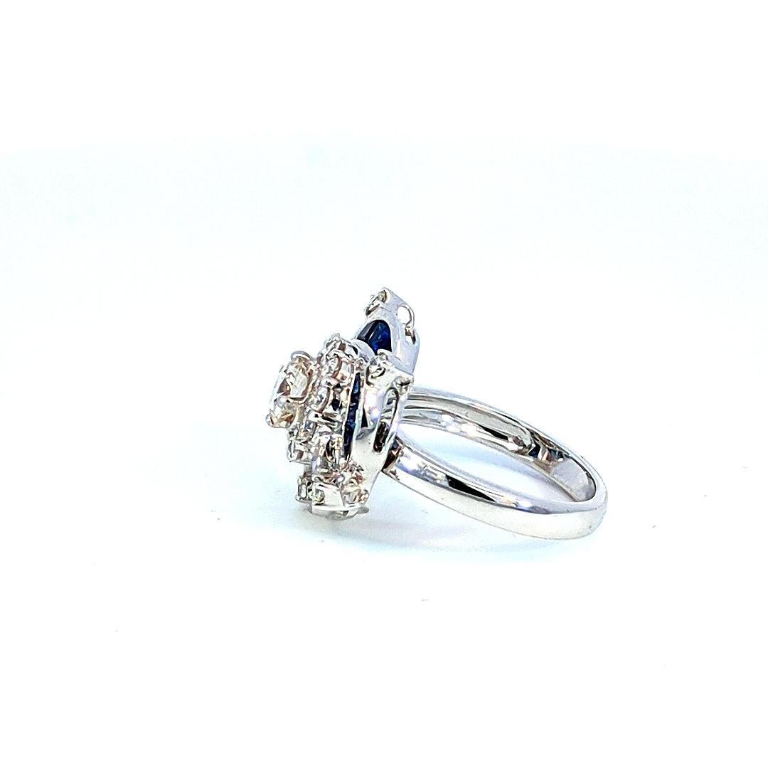 Introducing our stunning Diamond, Pearl, and Sapphire Cluster Ring, a mesmerizing piece that combines the timeless elegance of pearls with the sparkle of diamonds and the vibrant allure of blue sapphires. This ring is a true masterpiece,