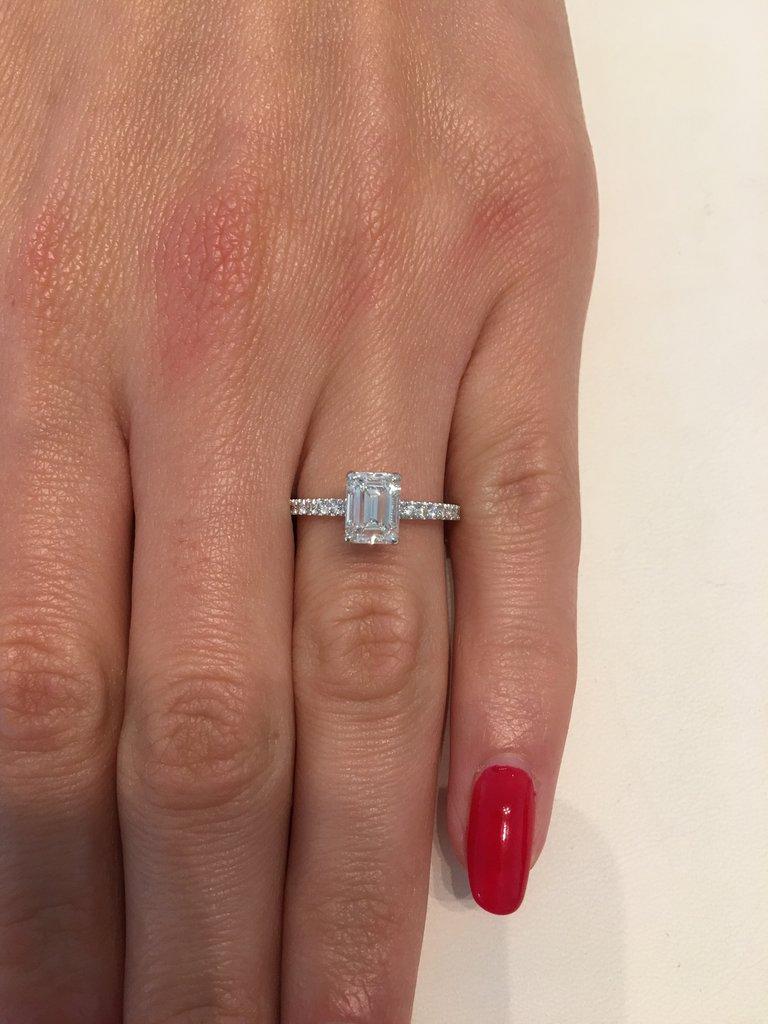 This incredible 1.56 ct diamond engagement ring will take your breath away!
The stunning 1.01 ct emerald cut center is GIA certified at H-VS2. White and very clean. Its wrapped with pave set diamonds underneath and floating atop a delicate diamond