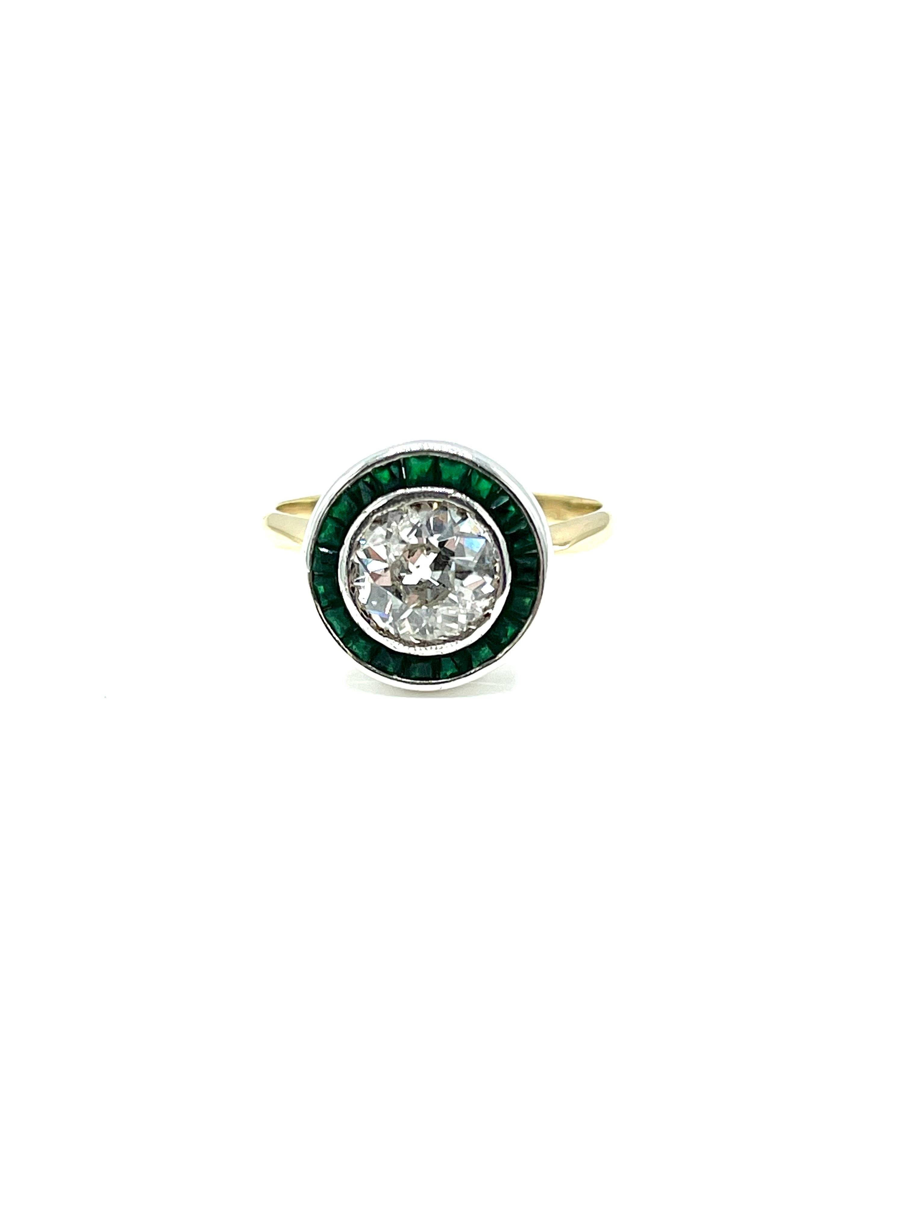 A beautiful French made old European cut Diamond engagement ring!  The ring is designed with a bezel set 1.56 carat old European cut Diamond, surrounded by a single row of square cut Emeralds, set in platinum, with an 18K yellow gold shank. The
