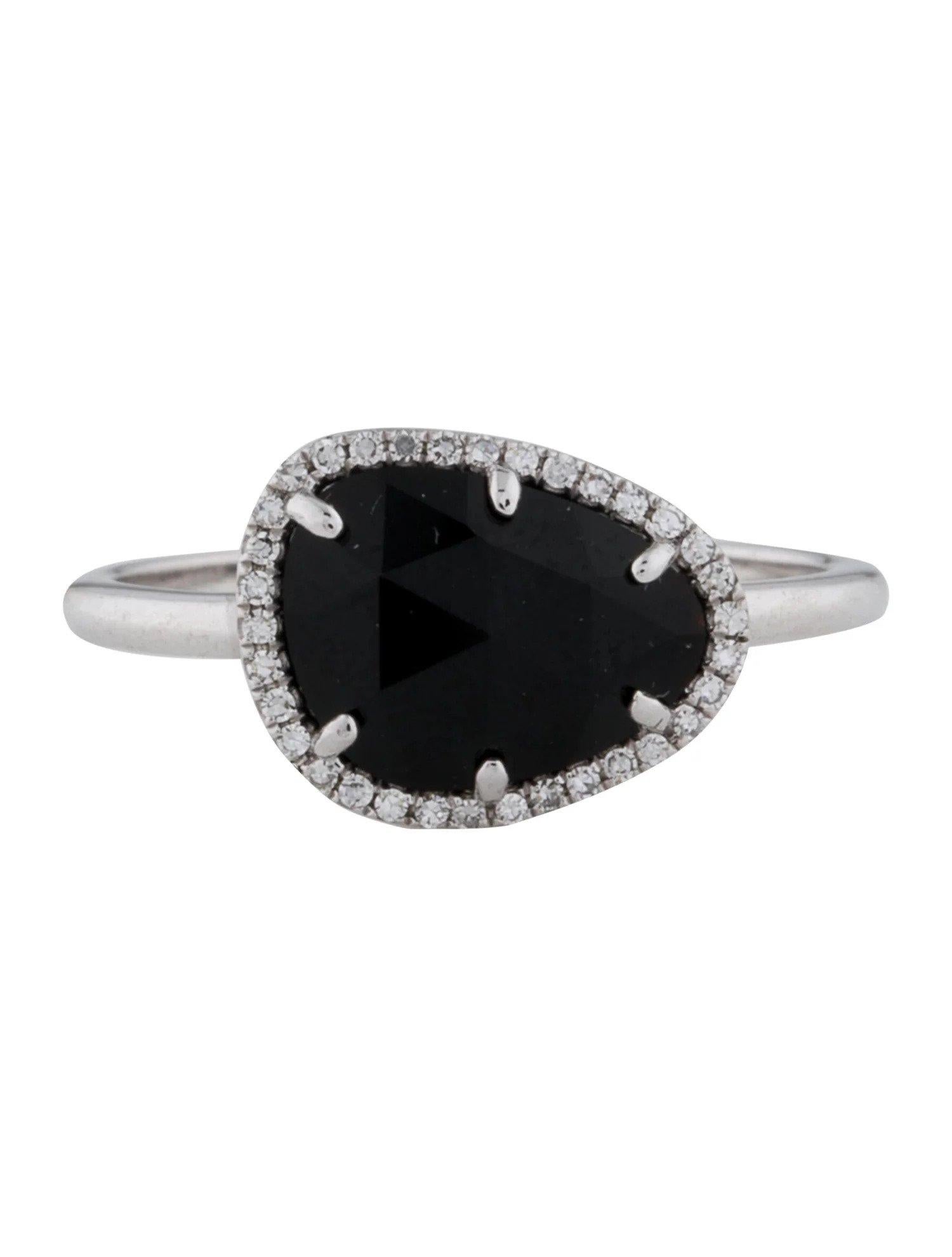 This Onyx & Diamond Ring is a stunning and timeless accessory that can add a touch of glamour and sophistication to any outfit. 

This ring features a 1.56 Carat Onyx (12 x 9 MM), with a Diamond Halo comprised of 0.08 Carats of Single Cut Round