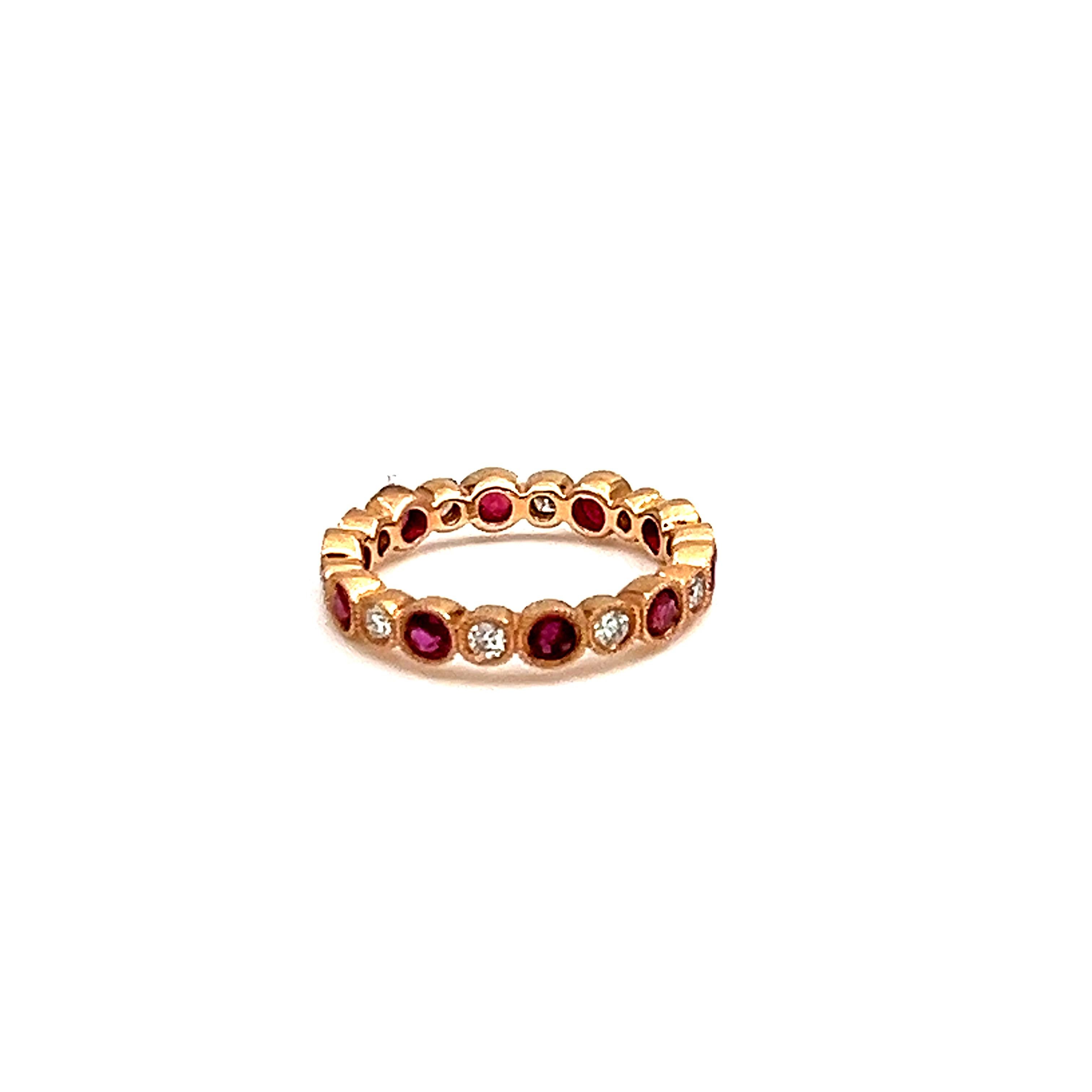 This stunning 1.56 ct ring set in 18k rose gold is a head turner. 10 natural rubies and 10 diamonds surround the ring.  E/F in color and VS1/VS2 in clarity. An amazing piece to add to your wardrobe. 