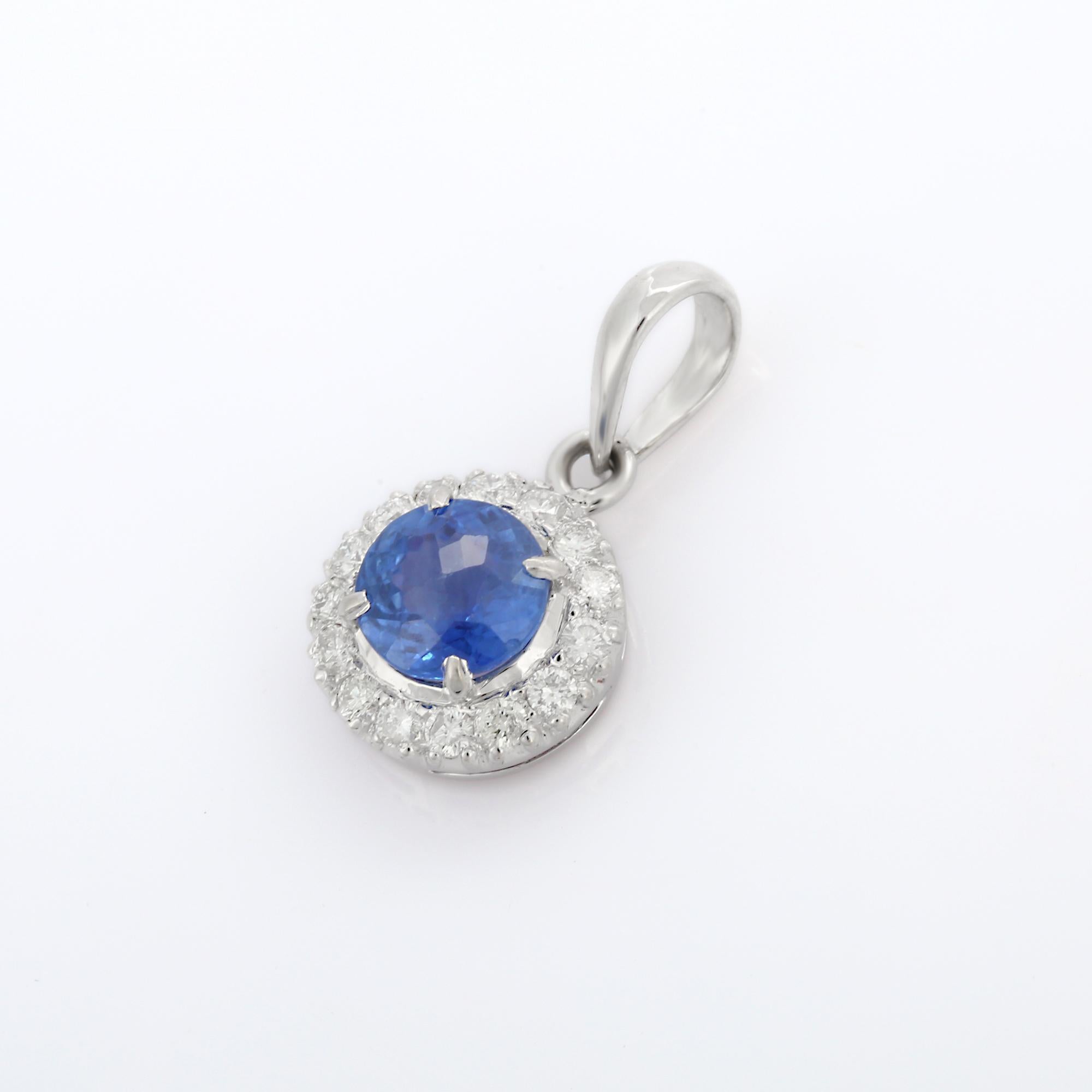 Natural Blue Sapphire pendant in 18K Gold. It has a round cut sapphire studded with halo of diamonds that completes your look with a decent touch. Pendants are used to wear or gifted to represent love and promises. It's an attractive jewelry piece