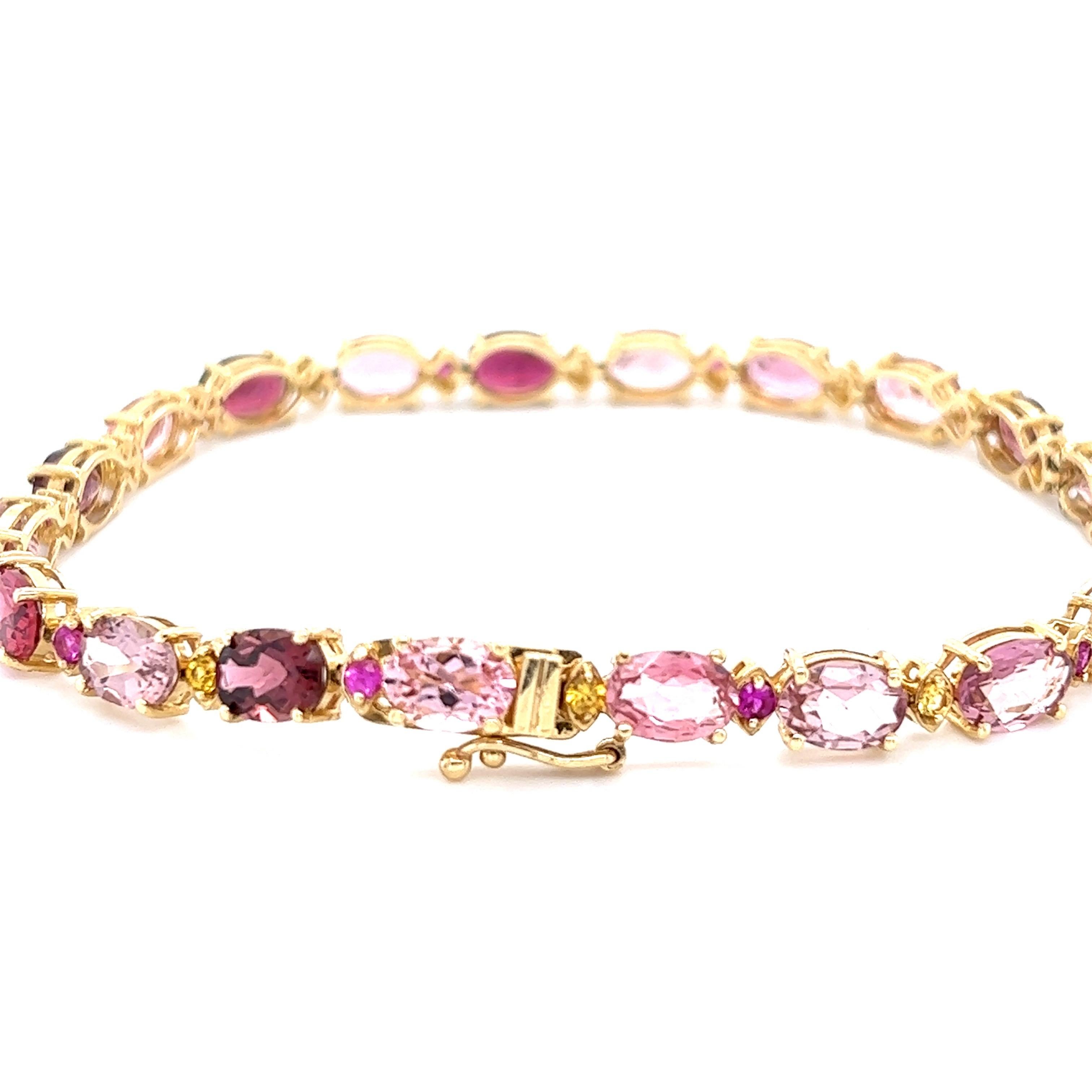 This Bracelet has 20 Natural Oval Cut Tourmalines that weigh 14.68 Carats. It also has 10 Round Cut Yellow Sapphires that weigh 0.48 Carats and 10 Round Cut Pink Sapphires that weigh 0.47 Carats. The total carat weight of the bracelet is 15.63