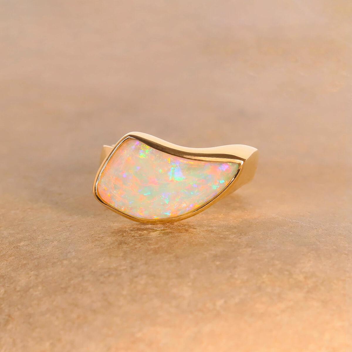 A beauty in its own category, this stunning light opal ring features an opalised shell fossil. This shell once lived on the edges of an inland sea in Central Australia. Over 100 million years the shell has become a solid opal in one of nature's true