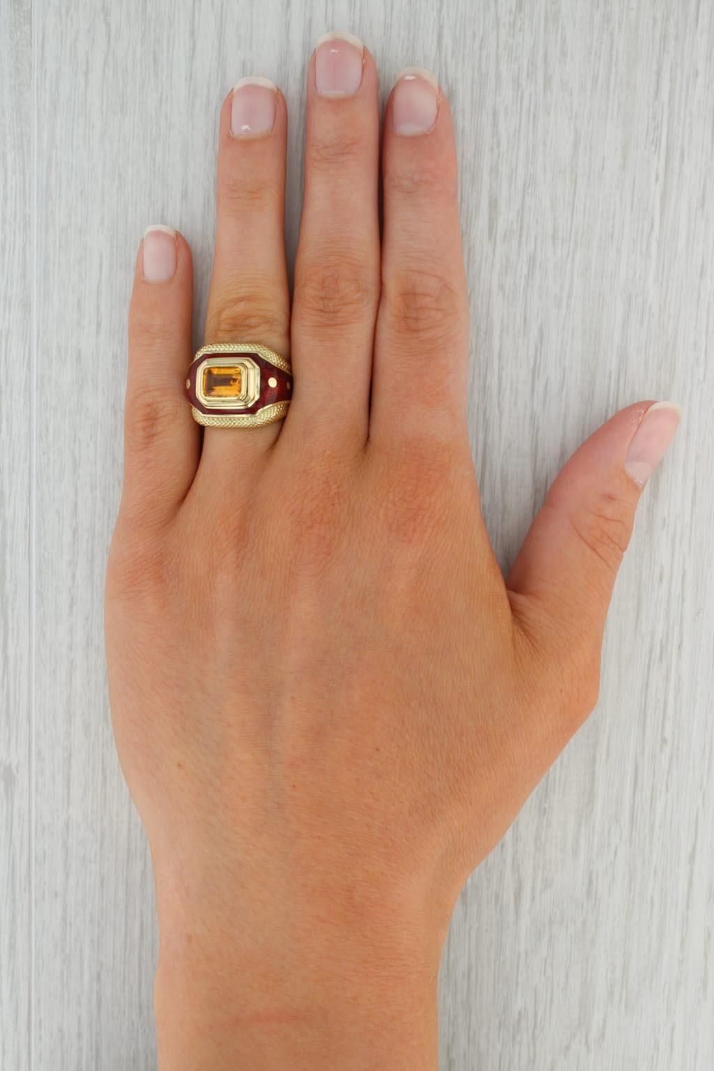 Gemstone Information:
- Natural Citrine -
Carats - 1.56ct (6.5 x 8.5 mm) 
Cut - Emerald
Color - Orange
Treatment - Heated

Material: Red Enamel
Metal: 18k Yellow Gold
Weight: 17.5 Grams 
Stamps: USA 18k Susy Mor
Face Height: 17.5 mm 
Rise Above