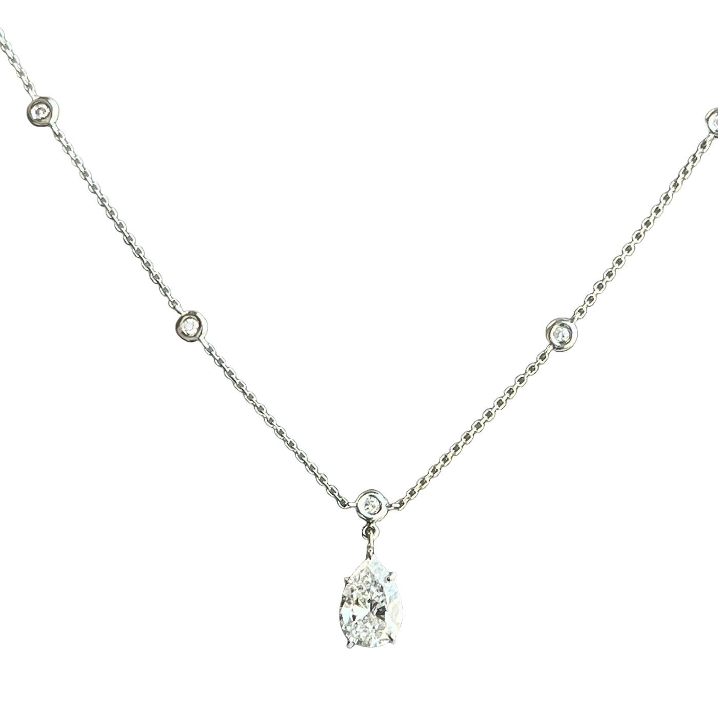 This exquisite pendant necklace with a pear-shaped diamond by the Yard in 14k white gold is both elegant and feminine. The 1.56ct carat pear-shaped center diamonds in this necklace come with 0.55ct on each (13 side stones) round diamonds. This