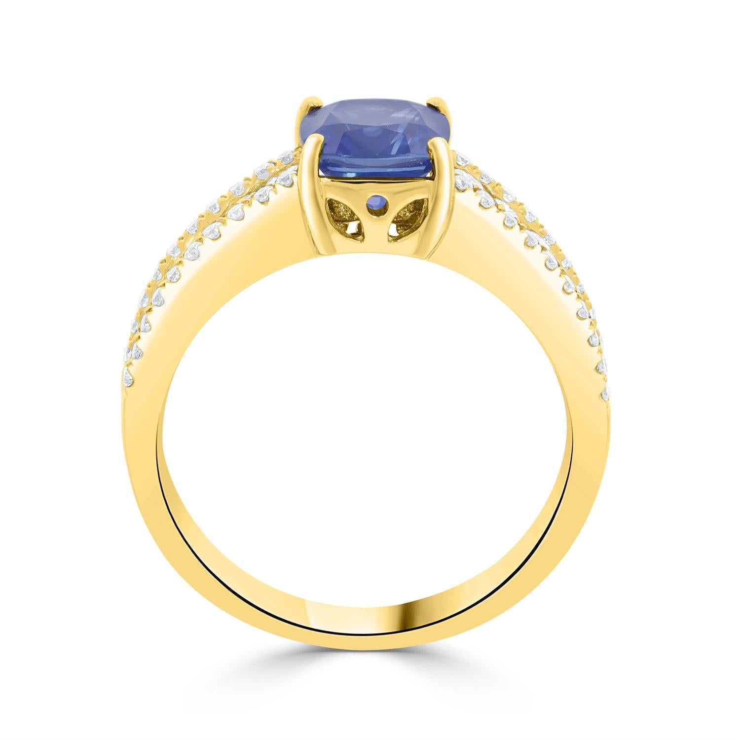 A splendid fusion of color and style, this ring is set with a cushion cut Sapphire, encircled by round cut Diamonds, and designed with 14K yellow gold.

At once stunningly classic yet absolutely unique, this ring's one of a kind design is sure to